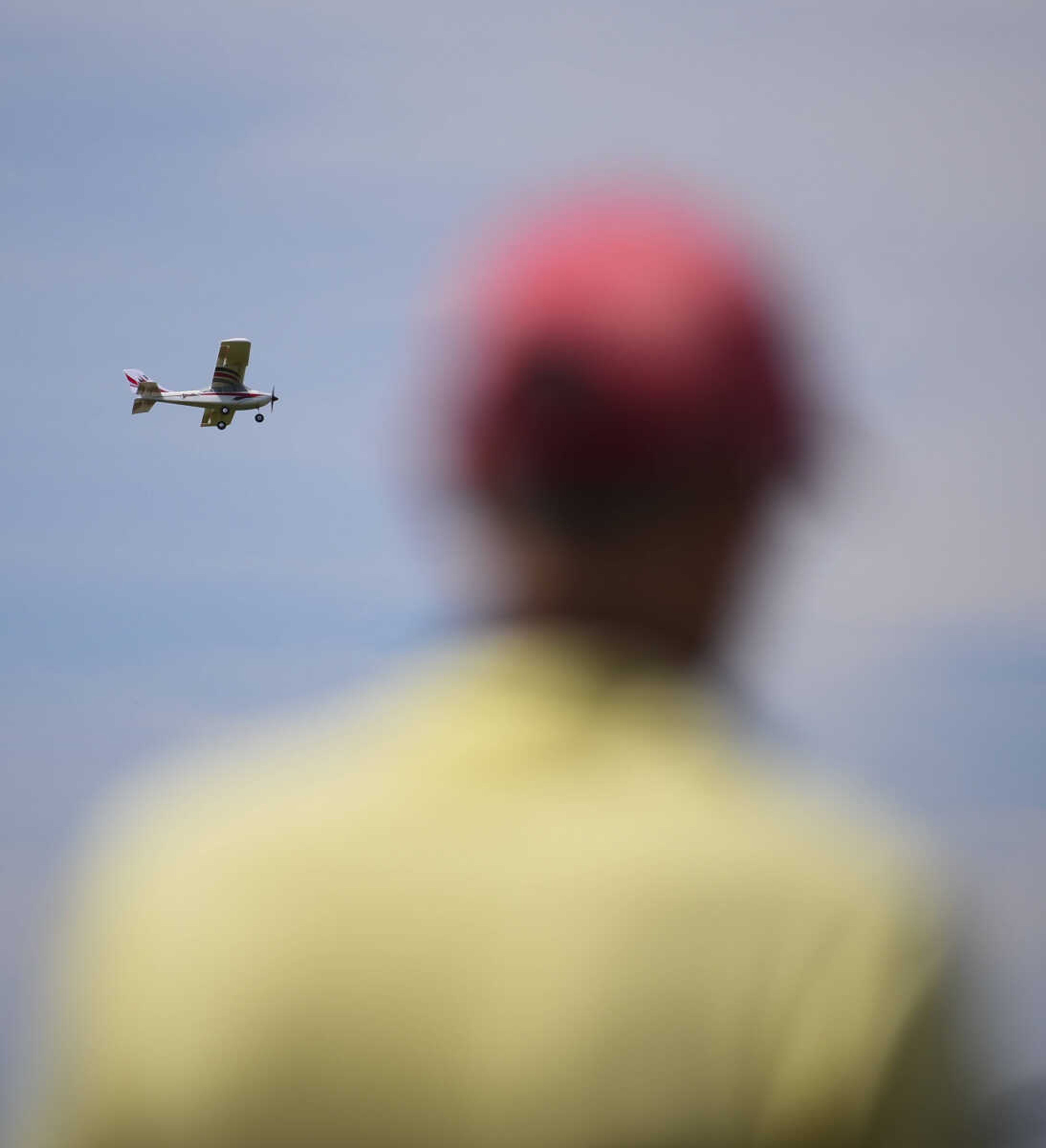 John Coffman watches as a model airplane fly through the air for the Cape Fly Hi radio controlled aircraft demonstration Saturday, June 3, 2017 at Galaxy Park in Cape Girardeau.