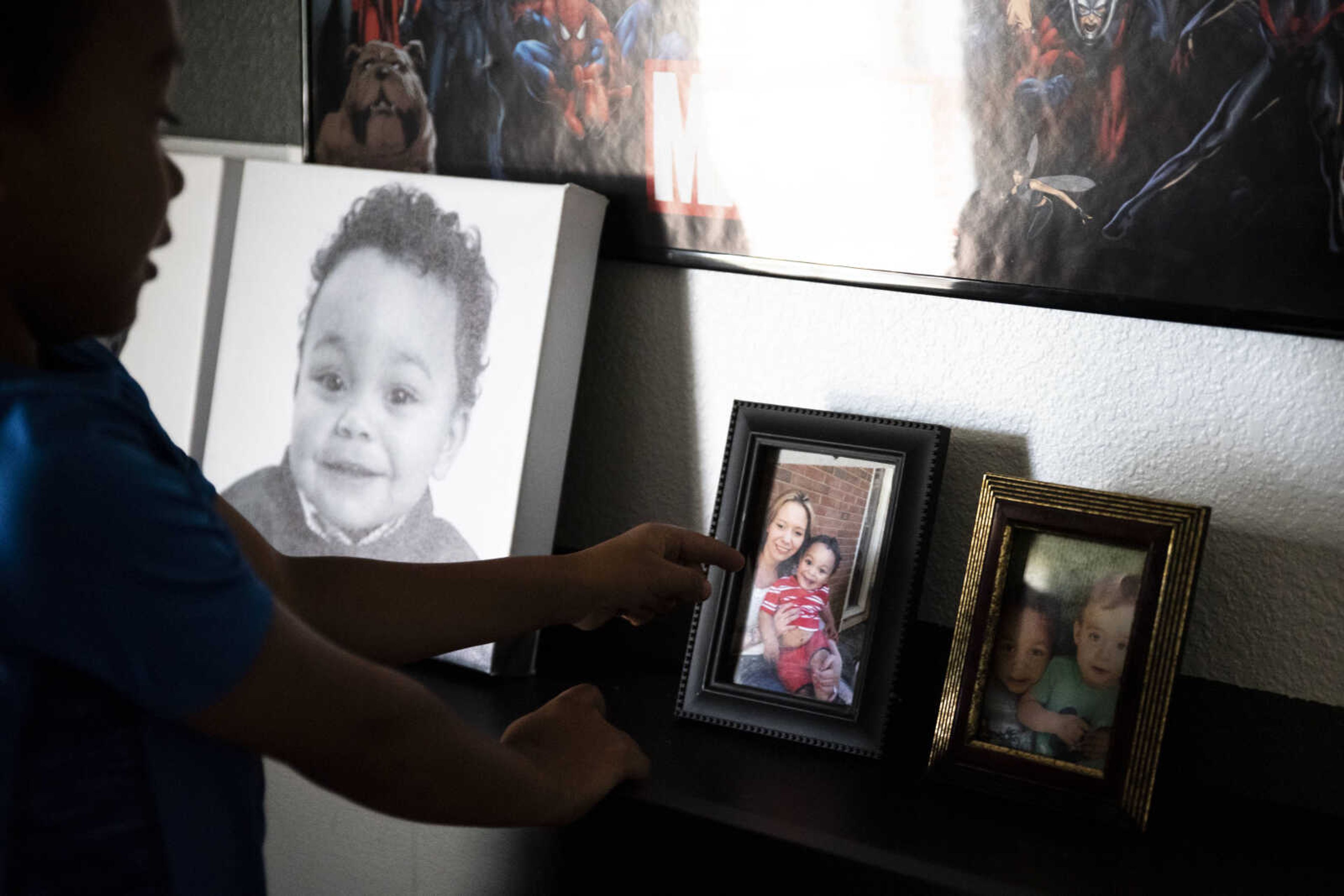 Jayce Holmes, 5, points to a photo of him and his mother, Daisha, resting on the headboard of his bed Tuesday, June 11, 2019, in Jackson. Daisha, like millions of other Americans, found herself caught in the ever-present opioid epidemic and overdosed when Jayce was just three years old.