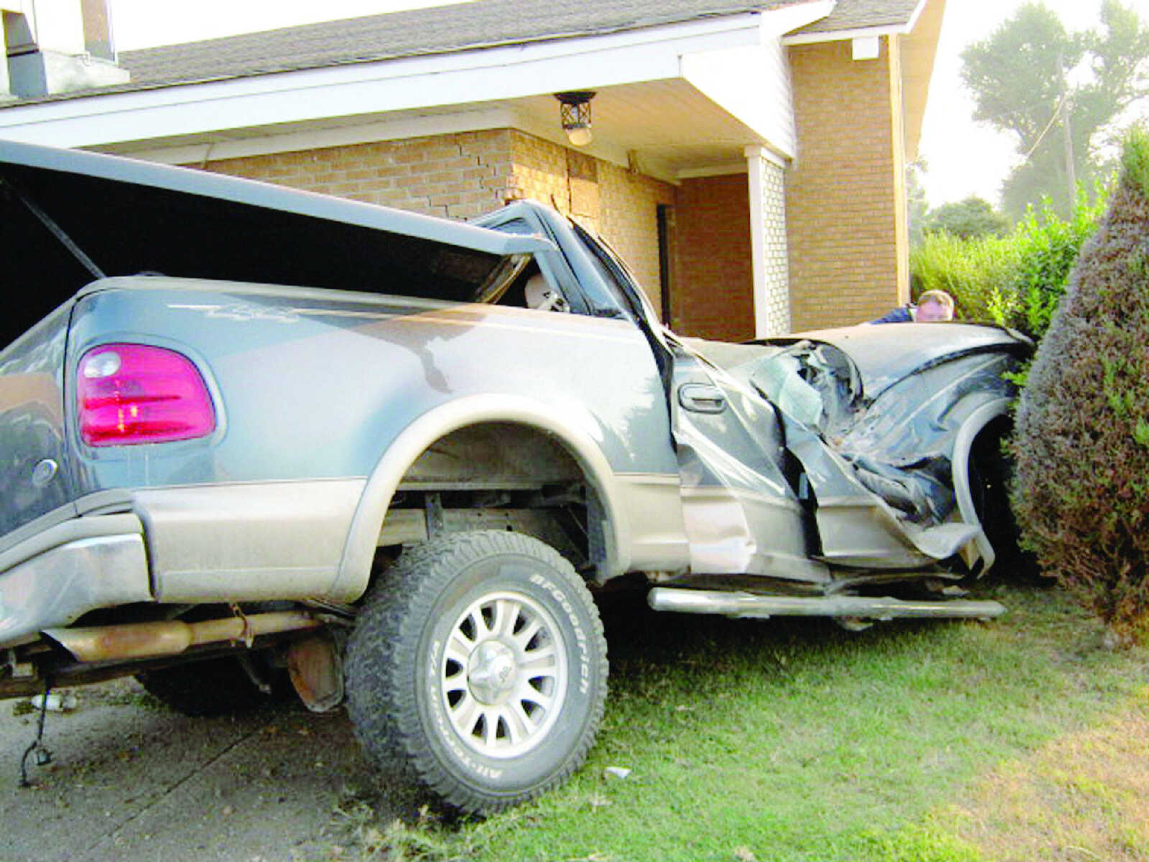 An Arkansas man's smashed truck lies against the First United Pentecostal Church building on the south side of Kennett following a single-vehicle accident on Sunday morning. (submitted photo)