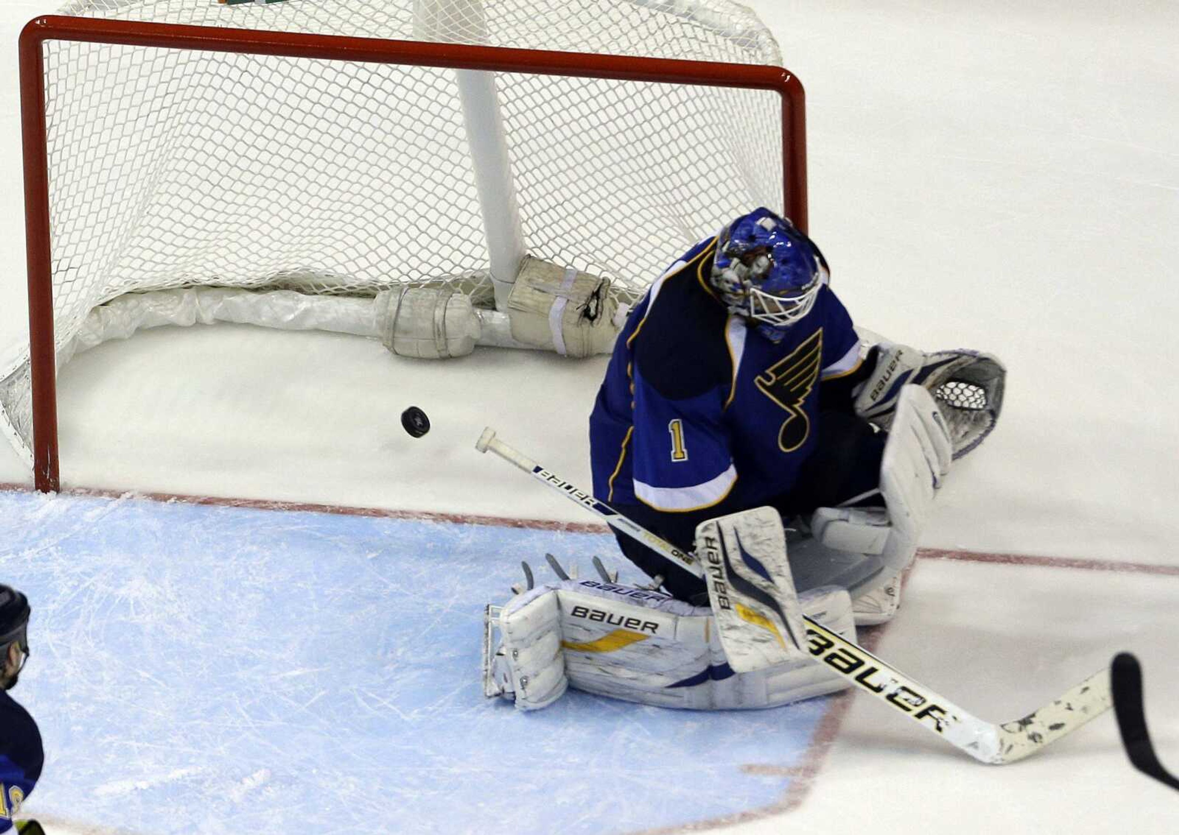 A shot by Los Angeles Kings' Slava Voynov, of Russia, slips past St. Louis Blues goalie Brian Elliott during overtime in Game 5 of a first-round NHL hockey Stanley Cup playoff series, Wednesday, May 8, 2013, in St. Louis. The Kings won 3-2. (AP Photo/Jeff Roberson)