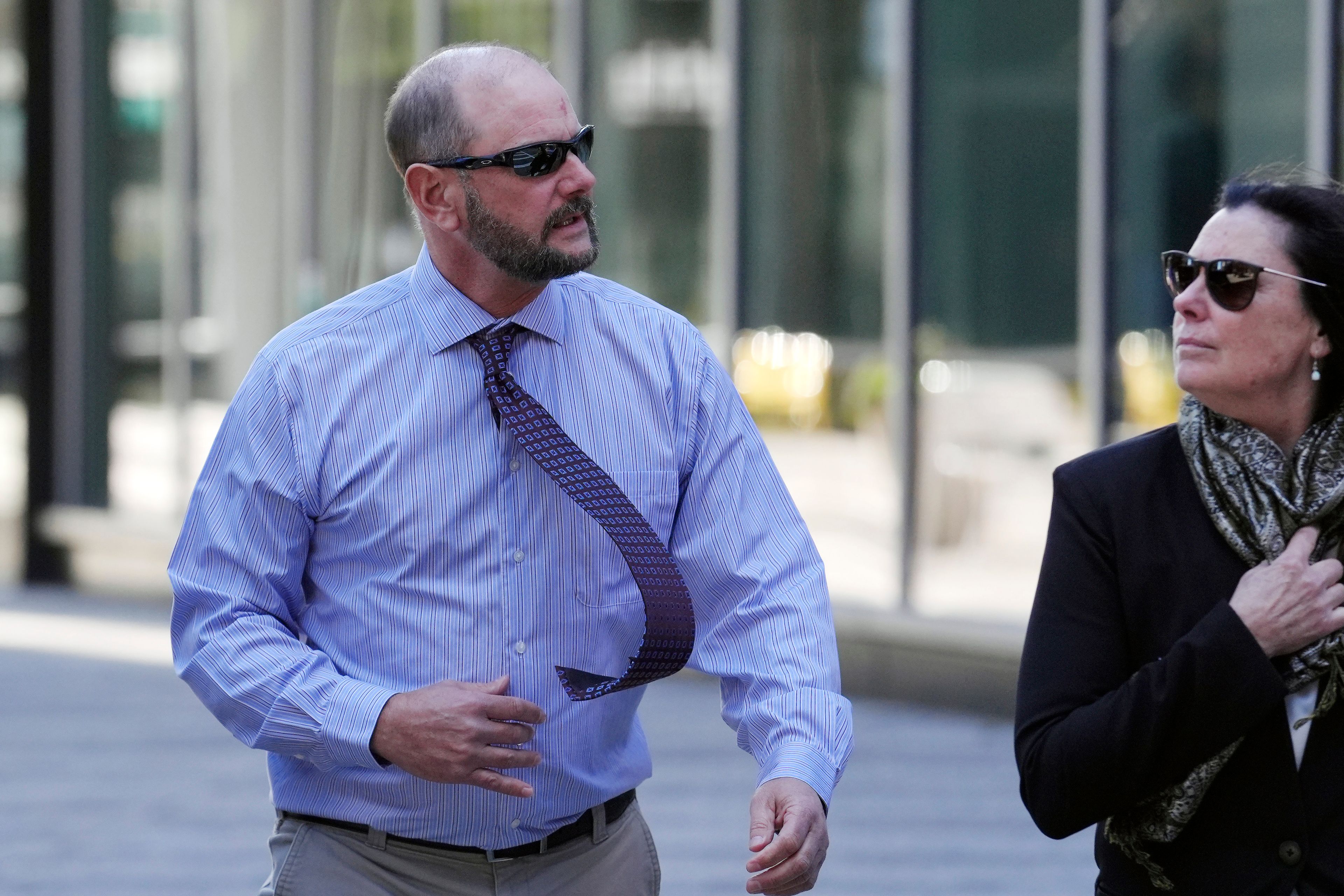 Jack Michael Teixeira, center, father of Massachusetts Air National Guardsman Jack Teixeira. arrives at federal court for his son's sentencing hearing, Tuesday, Nov. 12, 2024, in Boston,. (AP Photo/Steven Senne)