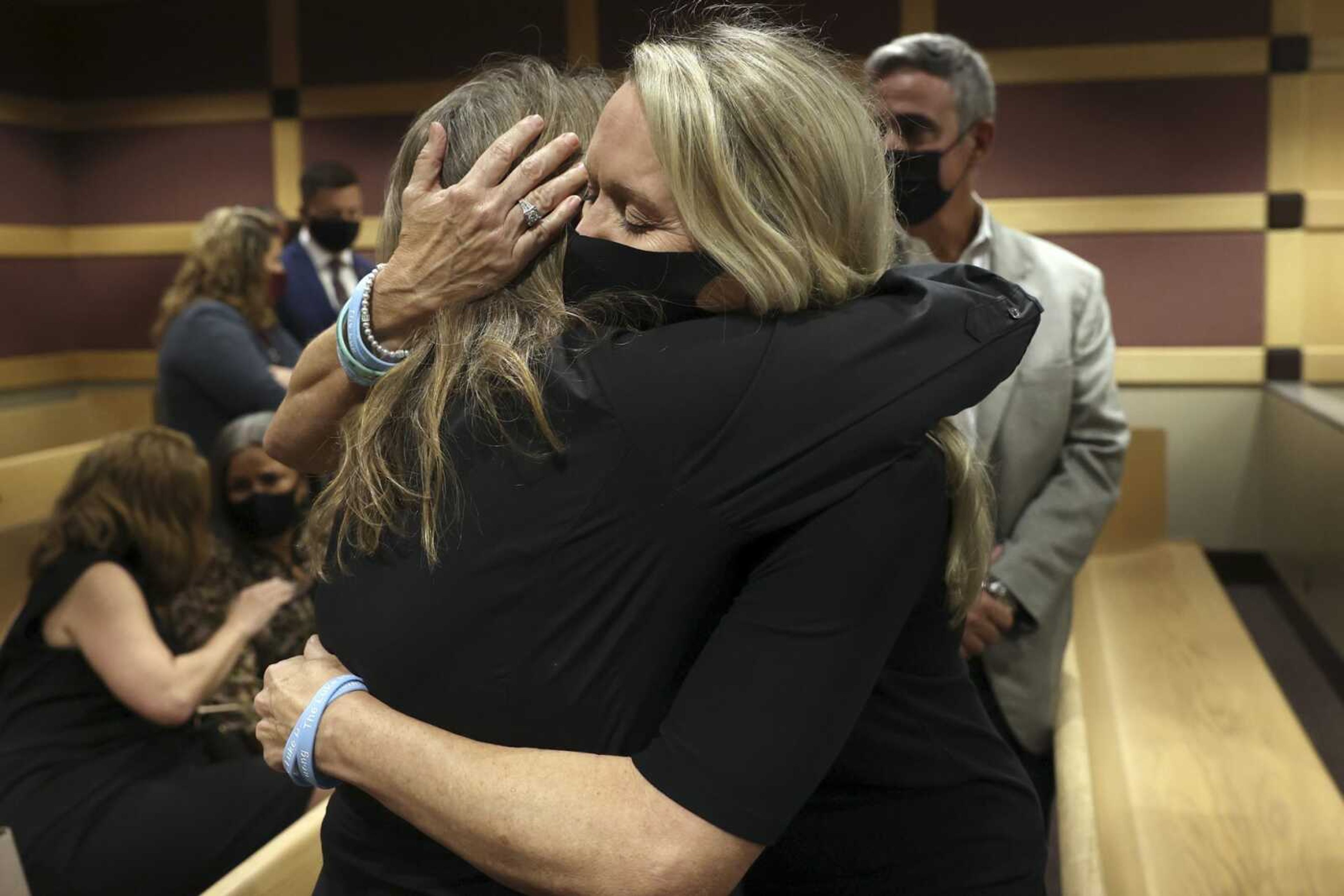 Gena Hoyer, right, hugs Debbi Hixon during a court recess following Marjory Stoneman Douglas High School shooter Nikolas Cruz's guilty plea on all 17 counts of premeditated murder and 17 counts of attempted murder in the 2018 shootings on Wednesday at the Broward County Courthouse in Fort Lauderdale, Florida. Hoyer's son, Luke Hoyer, 15, and Hixon's husband, Christopher Hixon, 49, were both killed in the massacre.