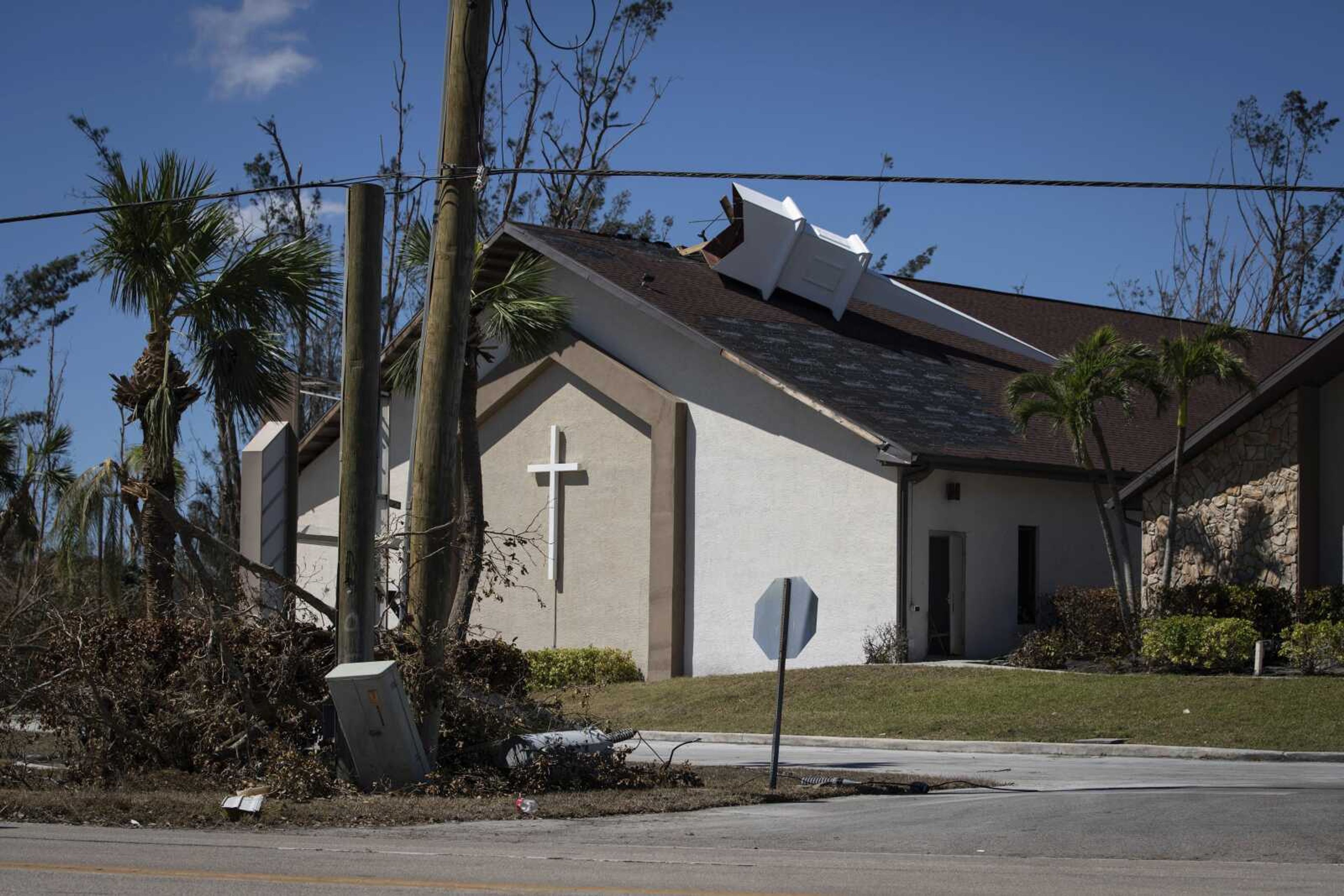 The steeple lays on its side atop Southwest Baptist Church on Sunday in Fort Myers, Florida. The church sustained heavy wind and flooding damage during Hurricane Ian as parishioners took refuge in the sanctuary.