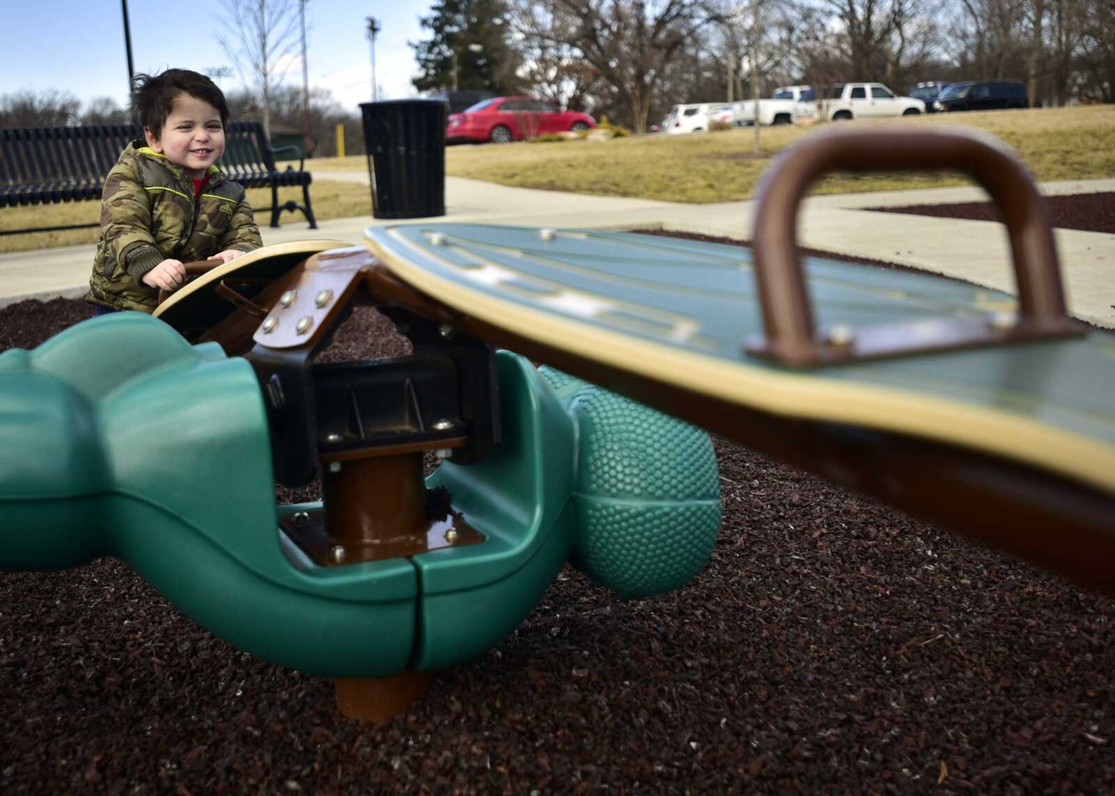 Allen Berlin, 2, bounces alone on a teeter totter Monday at Capaha Park in Cape Girardeau.