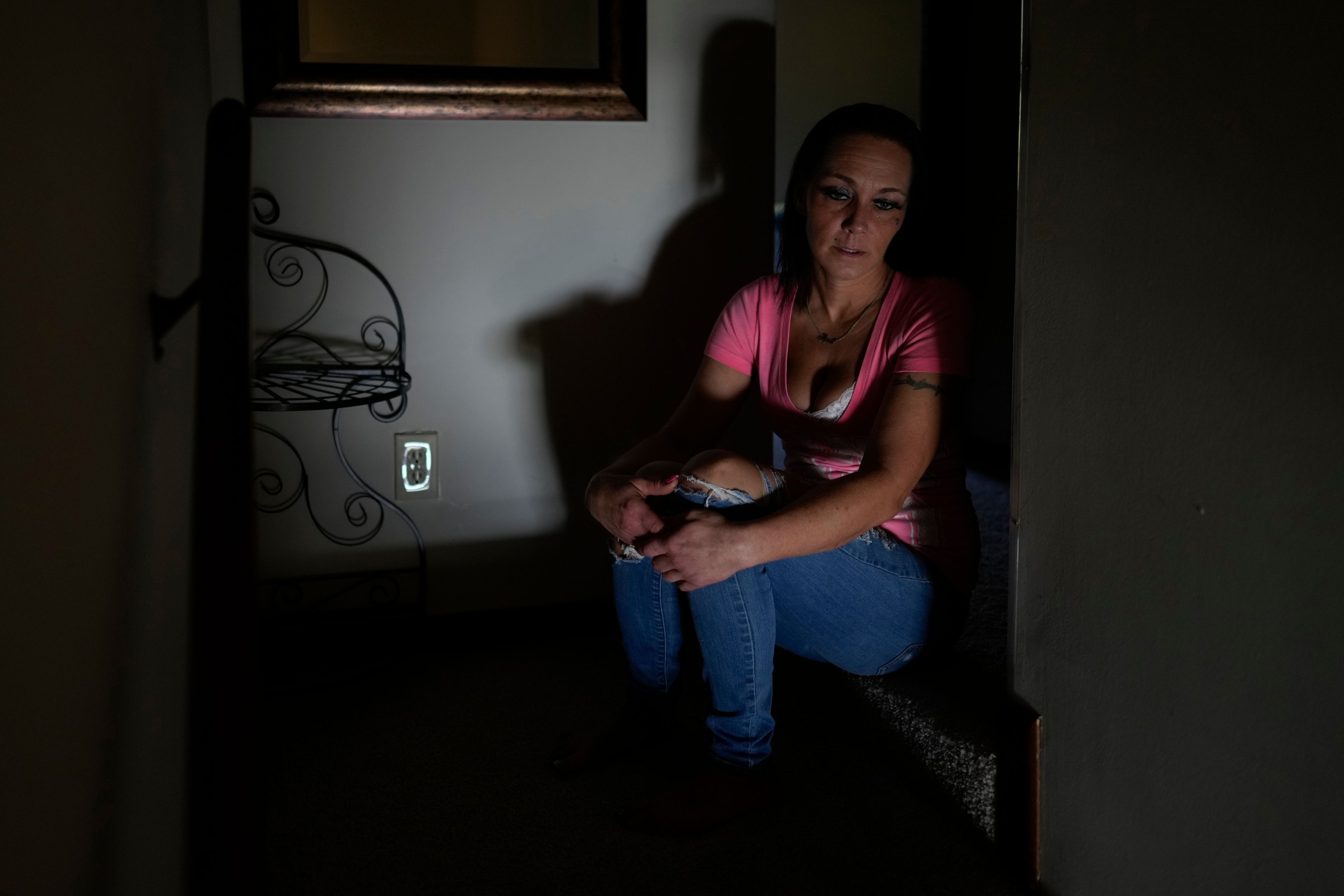 April Youst looks out from the top of the stairs in her West Virginia home on Wednesday, Oct. 9, 2024. (AP Photo/Carolyn Kaster)