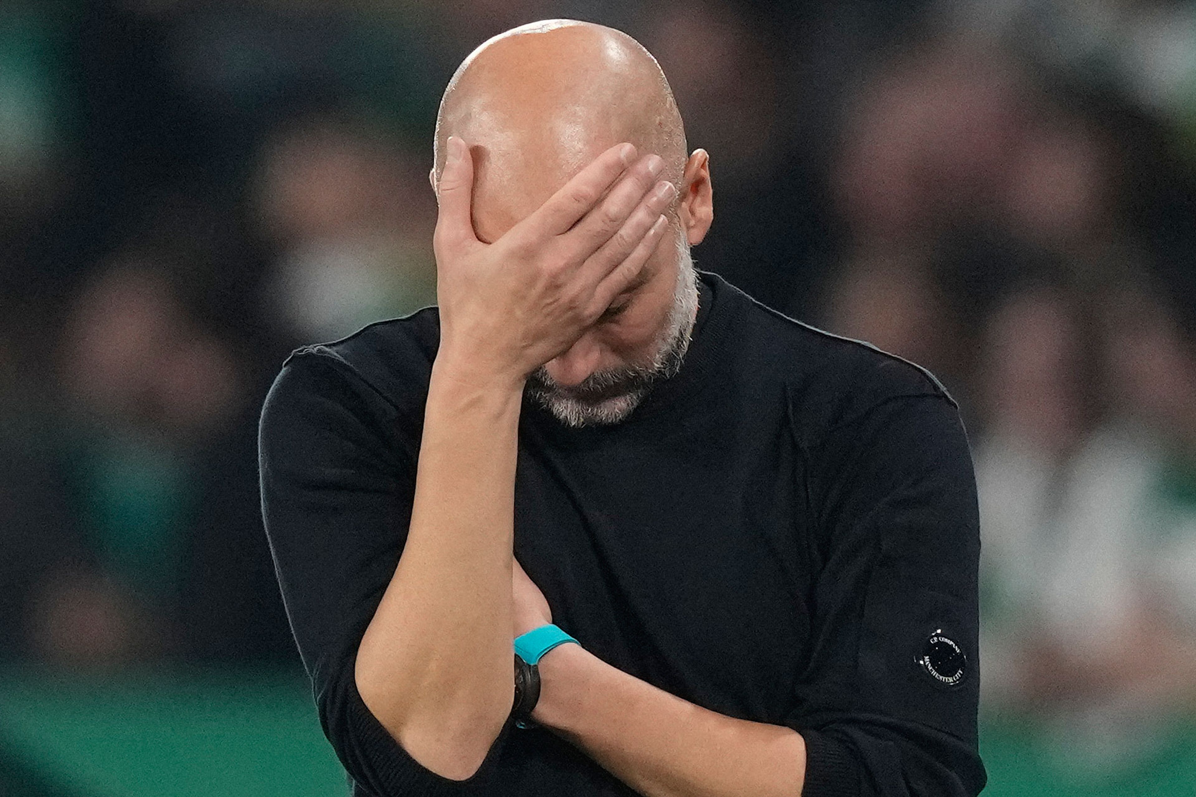 Manchester City's head coach Pep Guardiola reacts during the UEFA Champions League opening phase soccer match between Sporting and Manchester City in Lisbon, Portugal, Tuesday, Nov. 5, 2024. (AP Photo/Armando Franca)