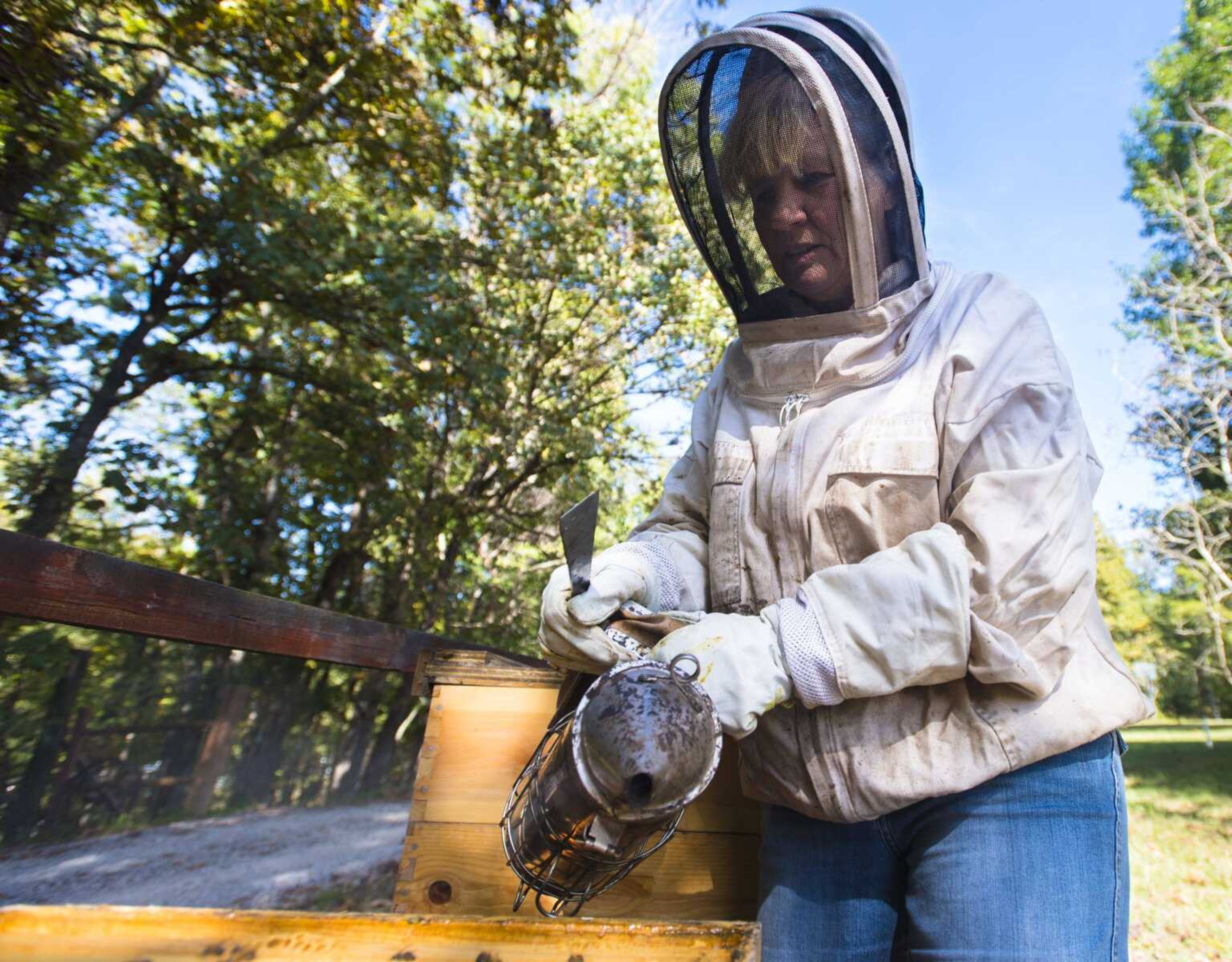 Carmen McNeely tends to her beehives Oct. 17, 2017 at her home in Fruitland.