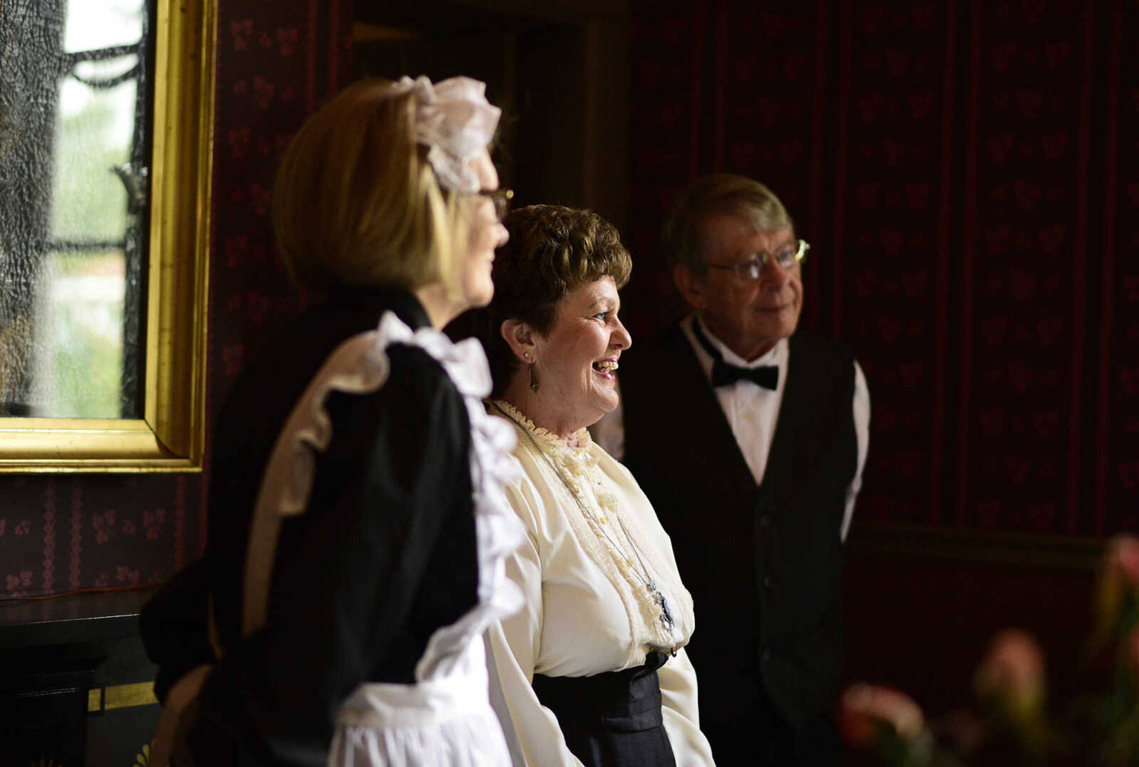 Linda Ingram, left, Mary Lou Bass, center, and Tom Bass, all dressed in period costume, visit inside the Glenn House dining room on Wednesday, Aug. 16, 2017, in Cape Girardeau. KMOS-TV, a PBS affiliate, was filming inside the historic home for its Missouri Life show.