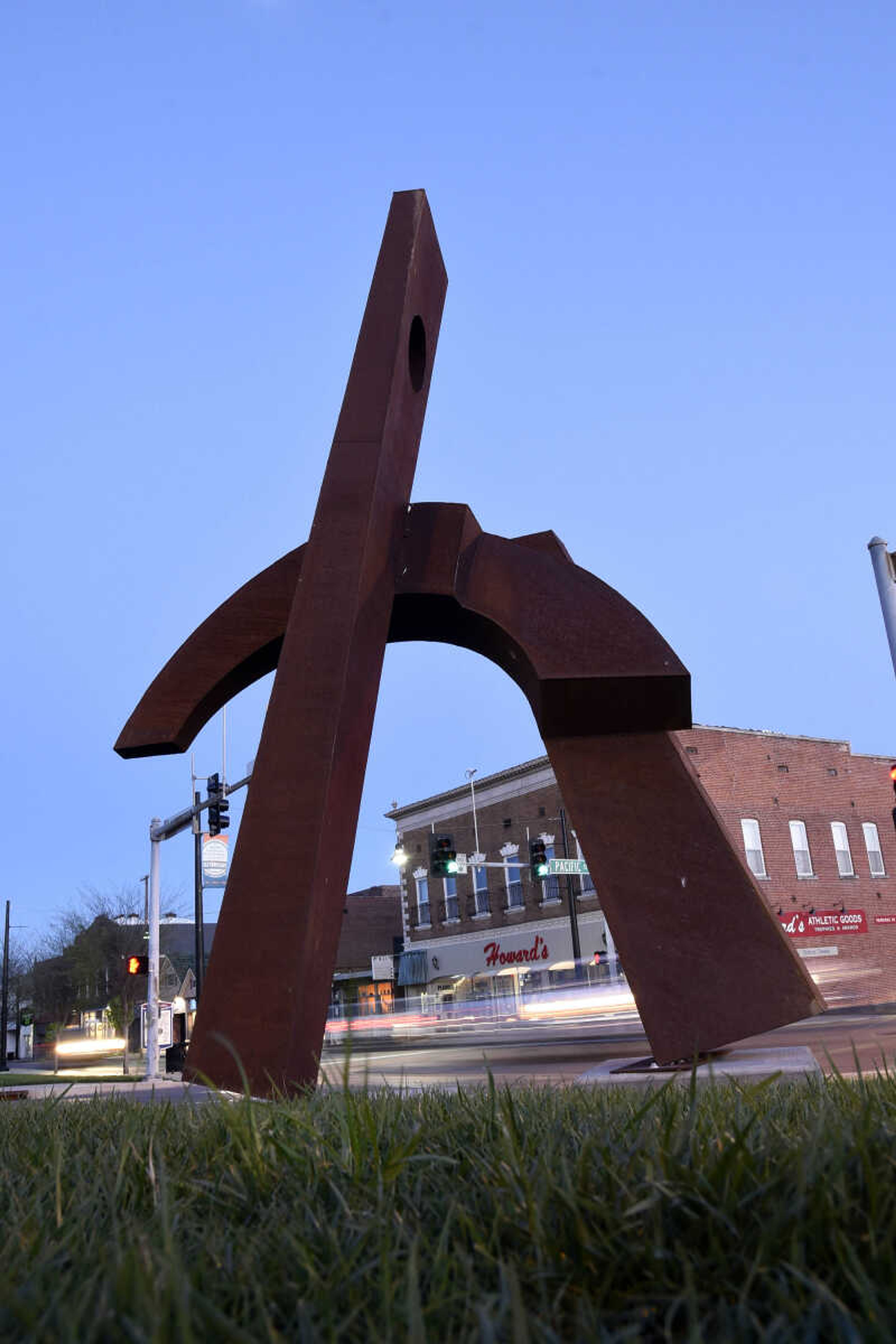 Traffic flows along along Broadway past James Johnson's sculpture, "The Seeker" on Thursday evening, April 6, 2017, in Cape Girardeau.