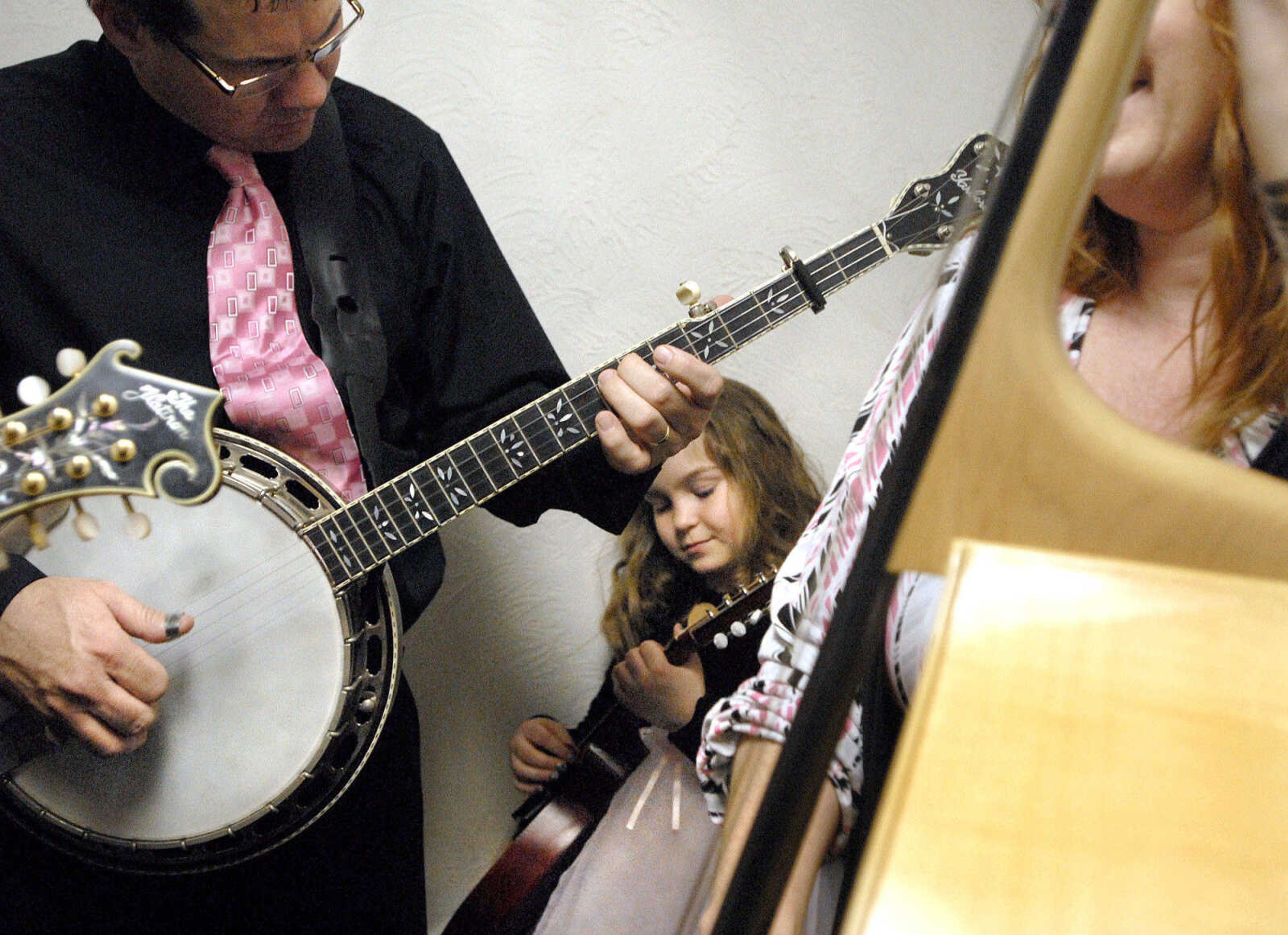 LAURA SIMON ~ lsimon@semissourian.com
Rodley, Molly and Jeanne Lewis practice before they take the stage Thursday night, January 26, 2012 during the Bootheel Bluegrass Festival at the Bavarian Halle in Fruitland