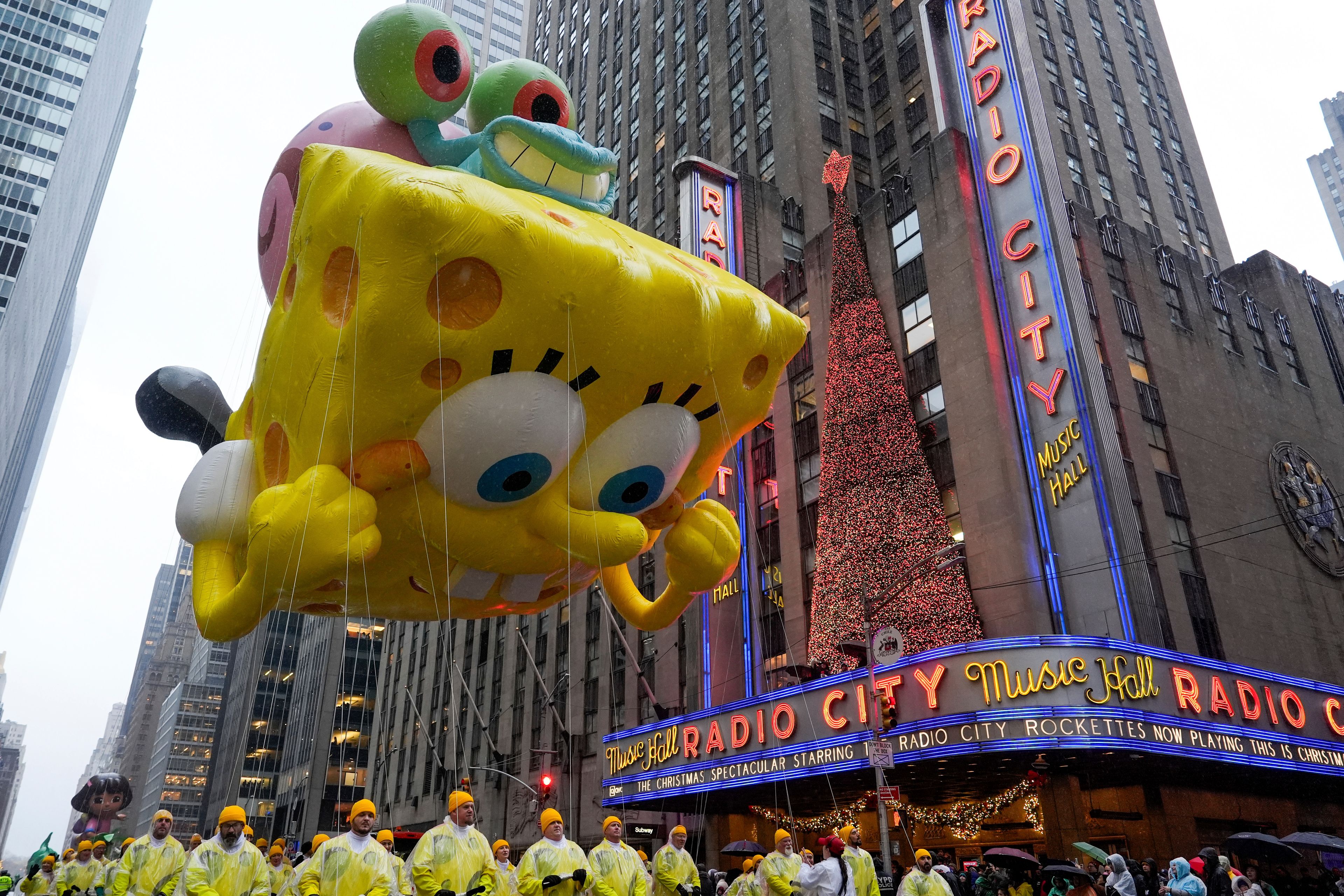 Handlers guide the SpongeBob SquarePants balloon down Sixth Avenue during the Macy's Thanksgiving Day Parade, Thursday, Nov. 28, 2024, in New York. (AP Photo/Julia Demaree Nikhinson)