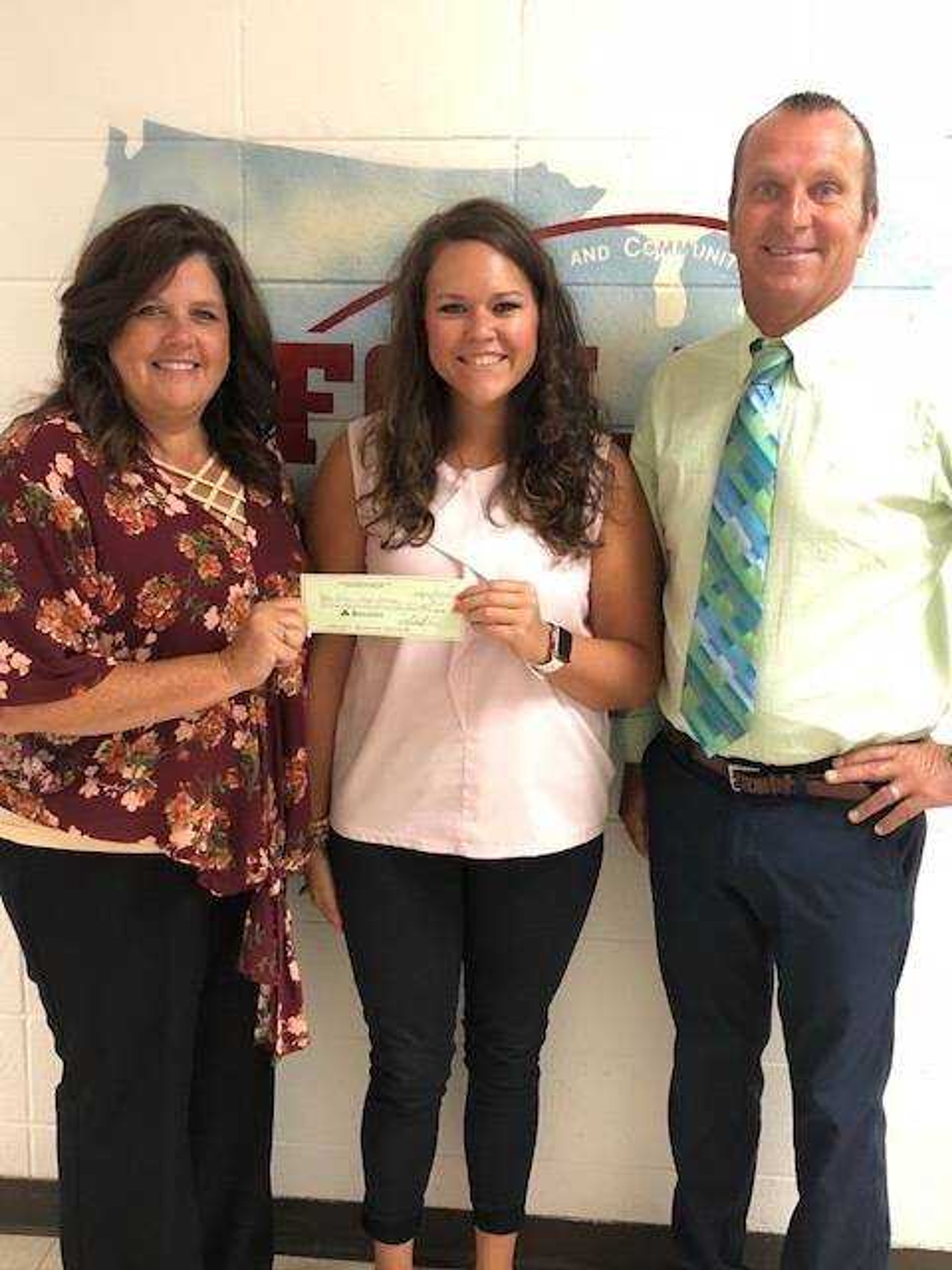 Presenting check on behalf of RMHC, Cheryl Farrow, Director of Operations for Shannon Davis Organization, and accepting check on behalf of Oran High School, Amy Wibbenmeyer, FACS Teacher, and Brad Coleman, Substitute Principal.