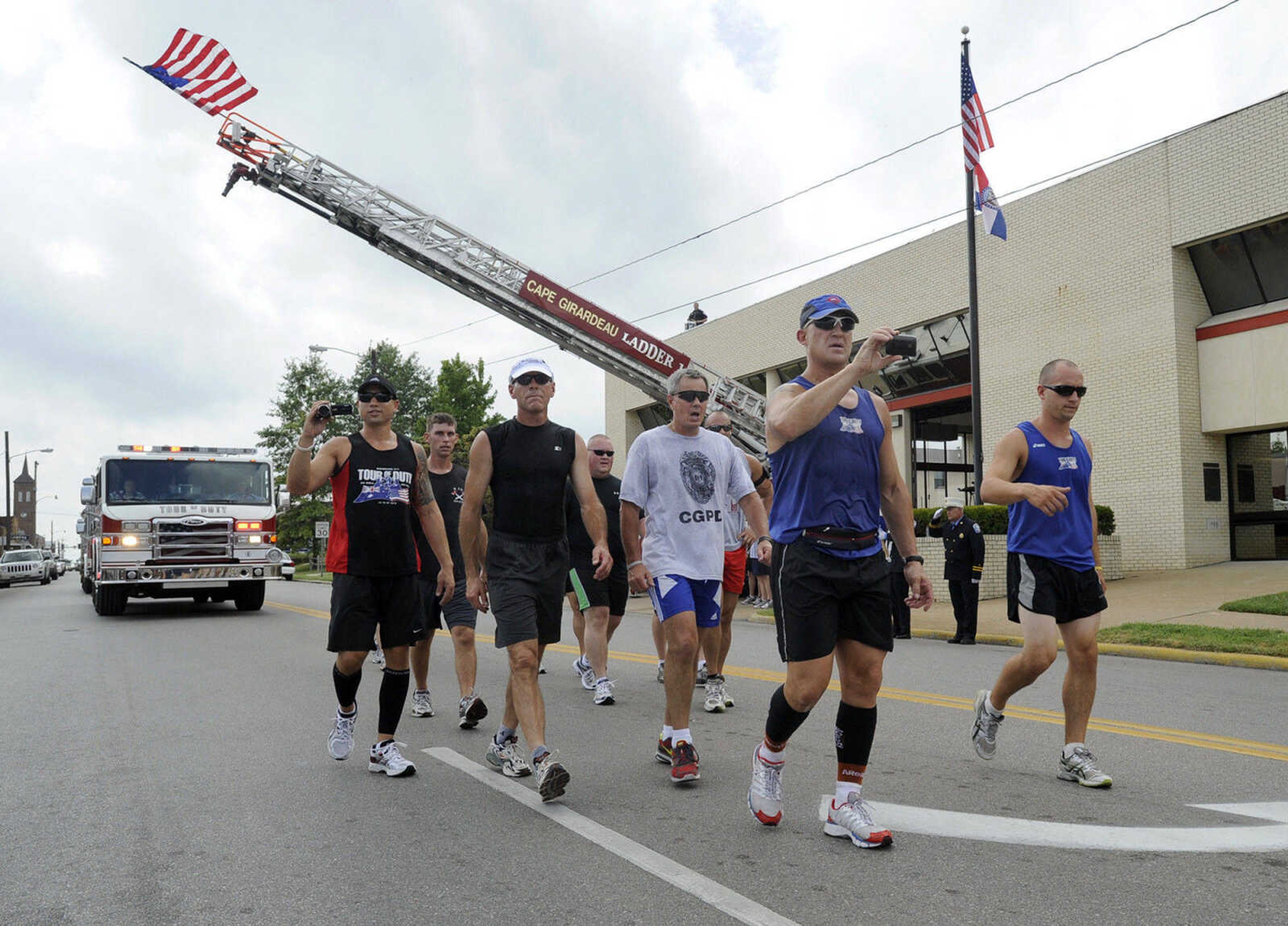 Members of the Tour of Duty Run pass by Fire Station No. 1 in Cape Girardeau Monday, Aug. 30, 2010 during the 4,600-mile, month-long journey from Los Angeles to New York City. Local fire and police personnel ran with the group as they were escorted through the city. According to its website, Tourofdutyrun.com, the run is an emotional statement. "We run to remember the people of 9/11, to honour their sacrifice, their courage, their devotion and commitment to duty." The group of 16 Australians and 18 Americans has been running in teams almost nonstop since Aug. 12, aiming to arrive in New York City on Sept. 11. (Fred Lynch)