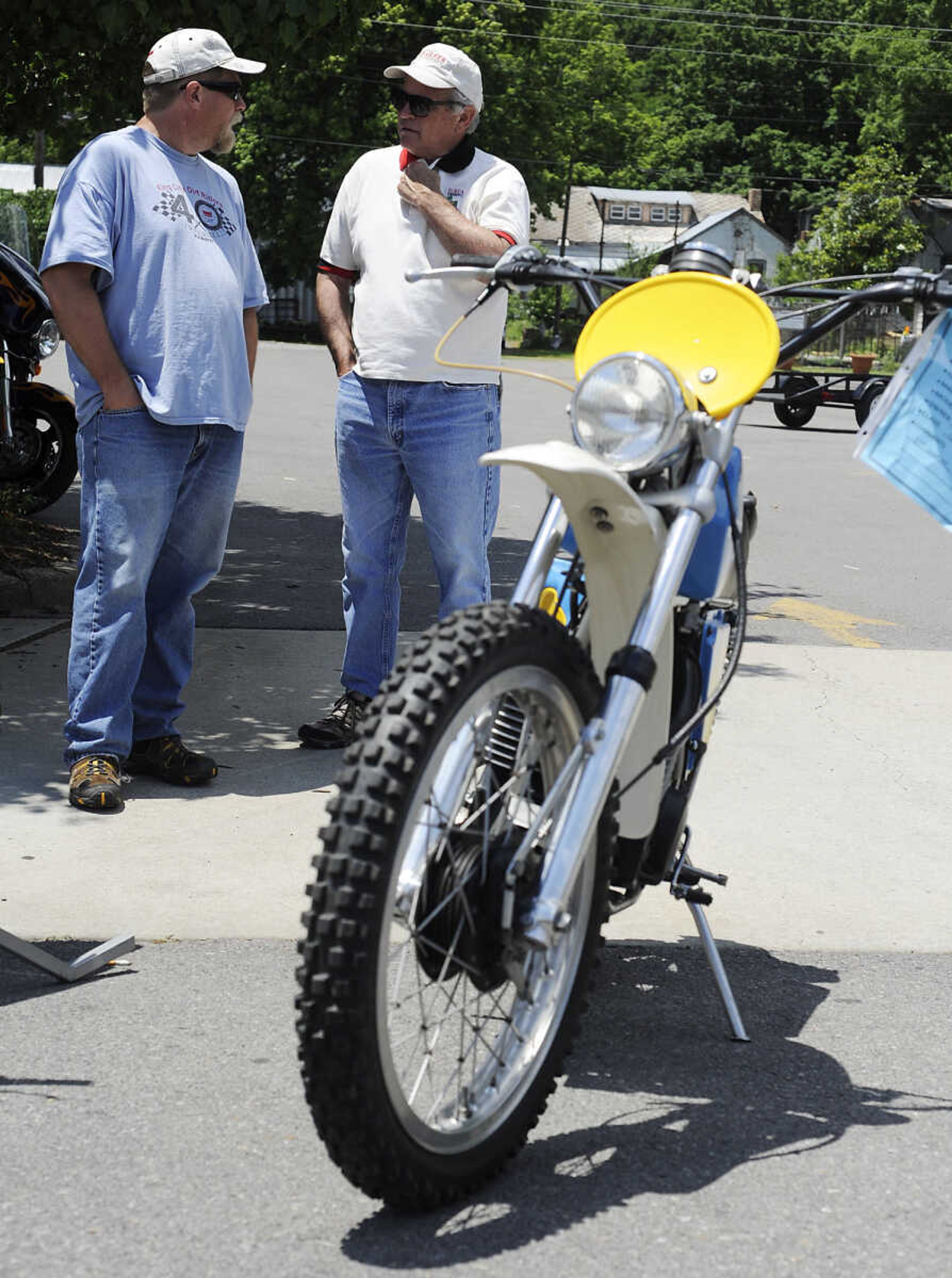 Jeff Keen, left, and Phil Campbell talk about Campbell's 1974 Penton 175 Jackpiner at the Bikes on the River Vintage Motorcycle Show Saturday, June 8, at Grass Roots BMW, 28 S. Spanish St., in Cape Girardeau. Approximately 50 vintage motorcycles, and numerous newer bikes, were on display at the show which is in its second year and sponsored by Grass Root BMW. While there was no entry fee money was collected to be donated to St. Jude Children's Research Hospital. Organizers plan on holding the show again next year.