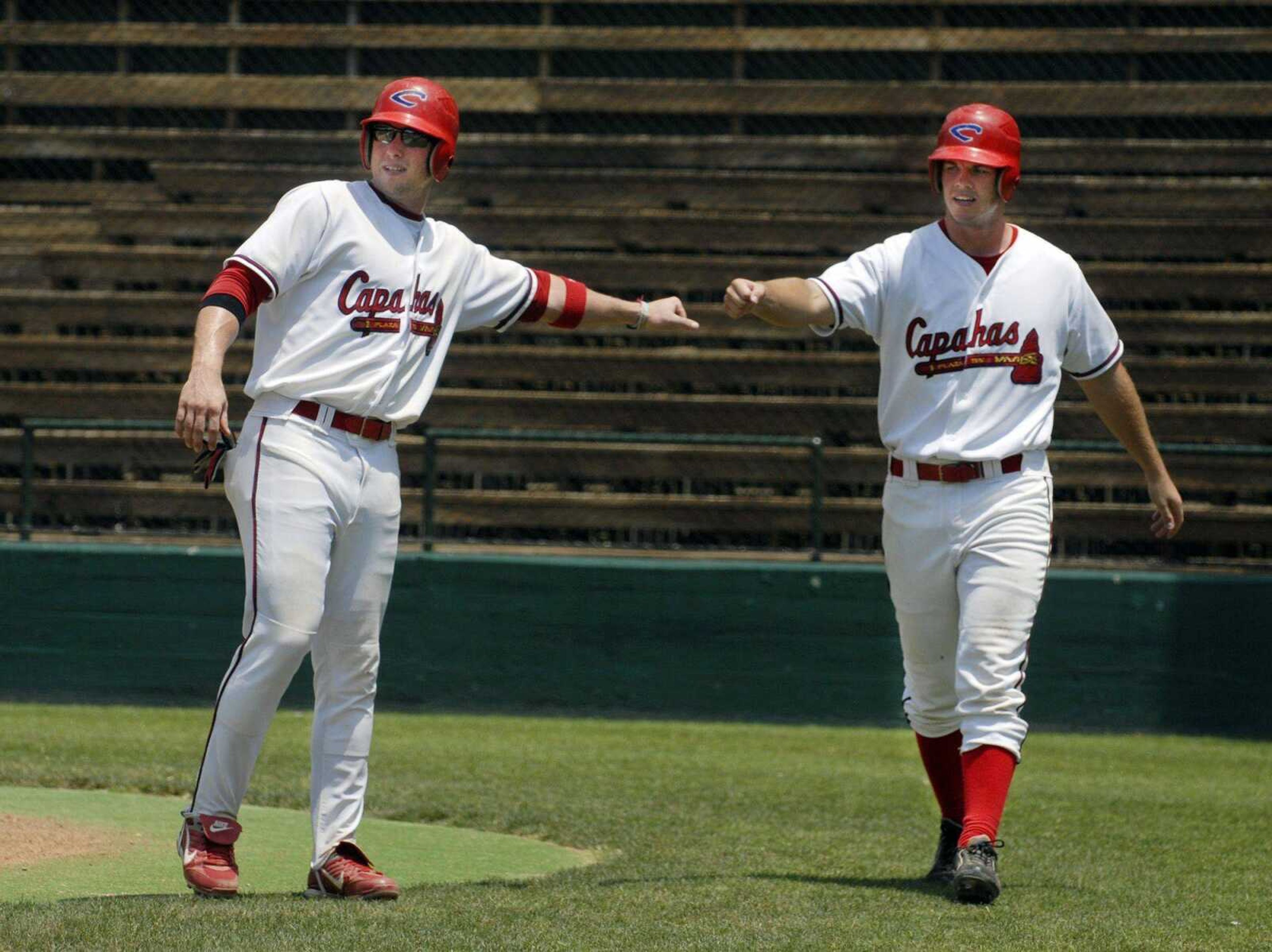 The Capahas' Daryl Graham, left, and Sean Bard congratulate each other after scoring during a victory in June against the Springfield Spikes at Capaha Field. The Capahas have a 25-10 record as they open play today at the NBC World Series in Wichita, Kan. (Kristin Eberts)