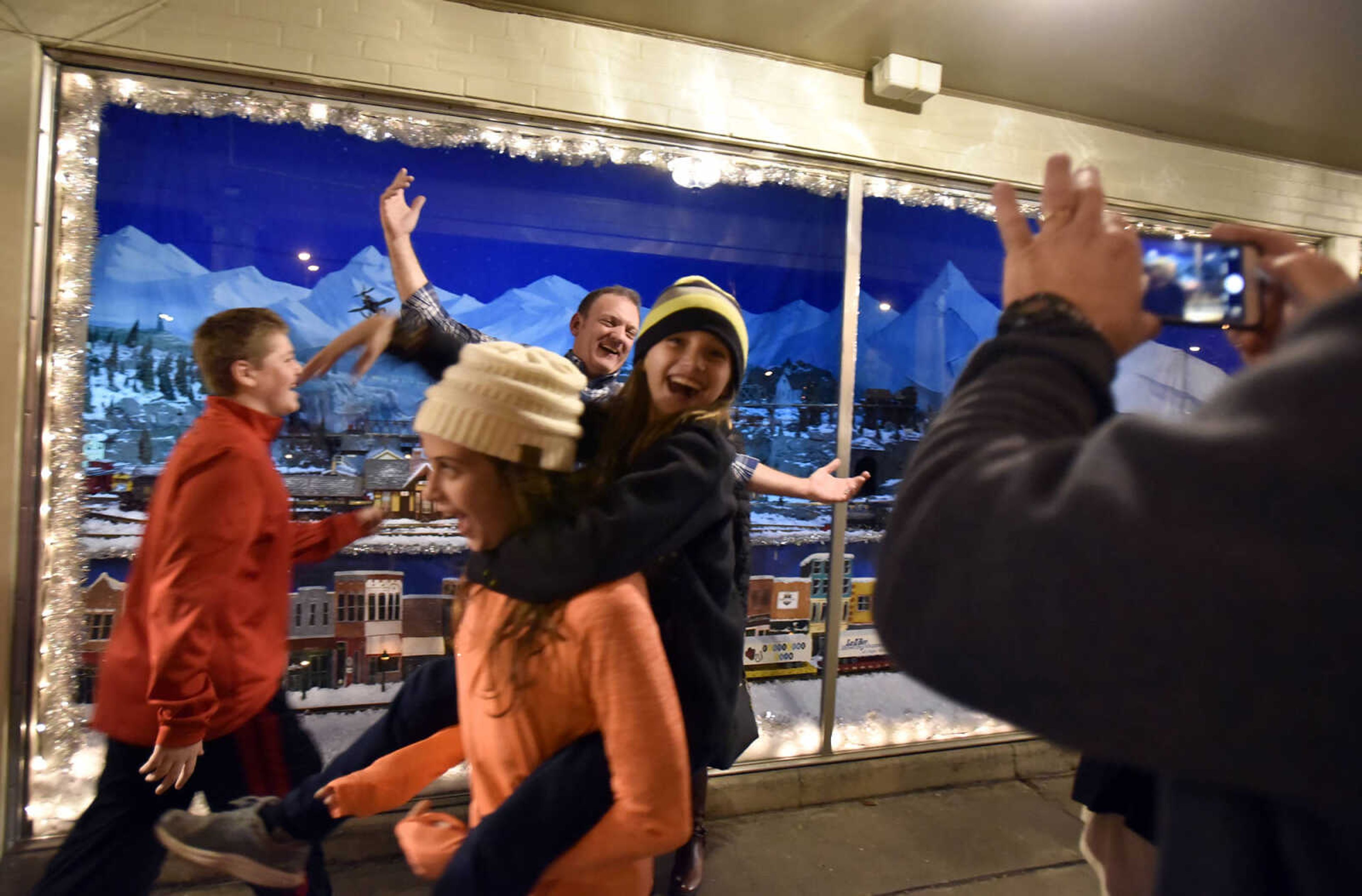 LAURA SIMON ~ lsimon@semissourian.com

Nick McLard, left, and Anna and Olivia Lacy, photo bomb Eric and Angie Olson in front of the annual Hutson's Fine Furniture Christmas window on Thursday, Nov. 24, 2016, in downtown Cape Girardeau.