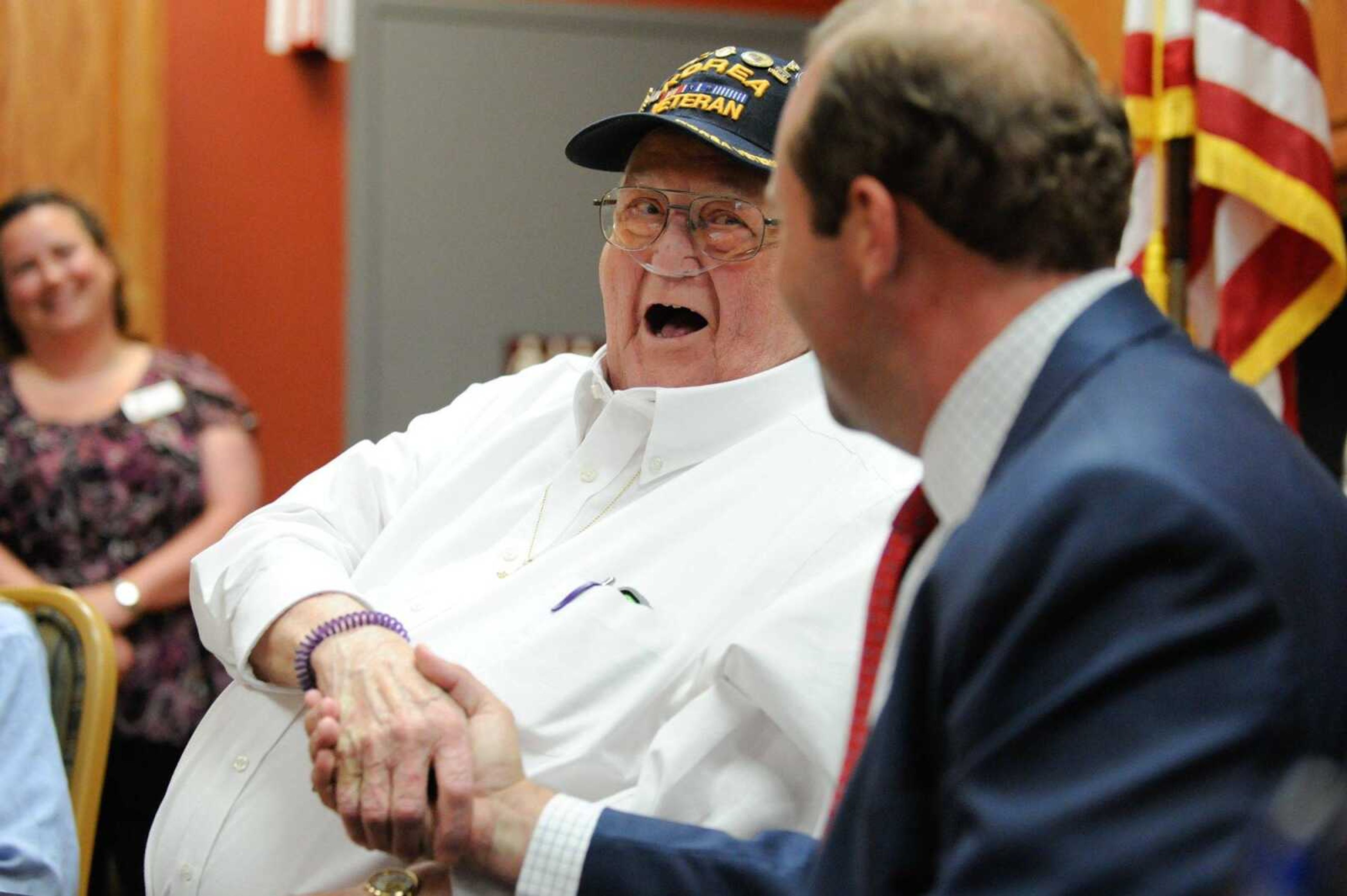 Raymond Burbach shakes hands with U.S. Rep. Jason Smith on Wednesday after receiving seven awards and accolades for his service in the Korean War at the Missouri Veterans Home in Cape Girardeau.