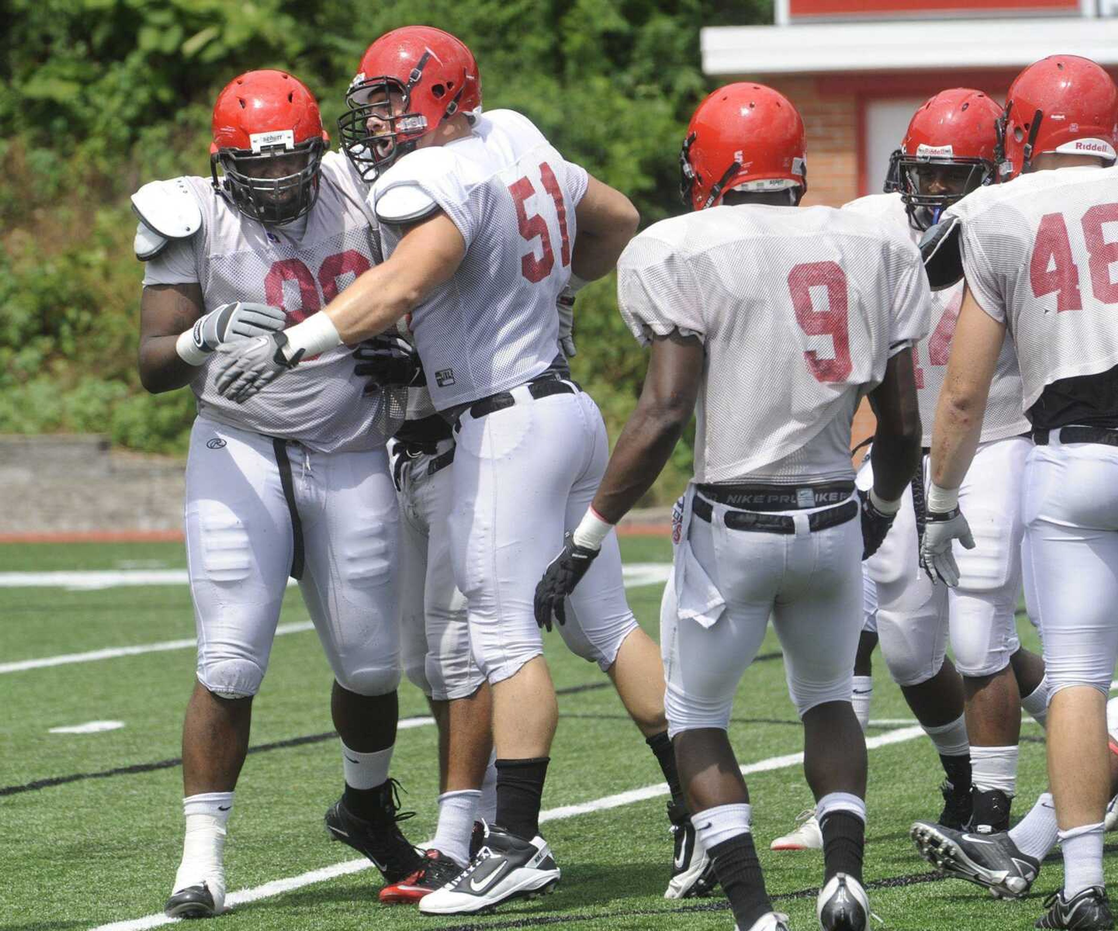 Southeast Missouri State defensive lineman Steve Hendry (51) celebrates a tackle made by Frankie Davis, left, during Saturday's scrimmage at Houck Stadium. (Fred Lynch)