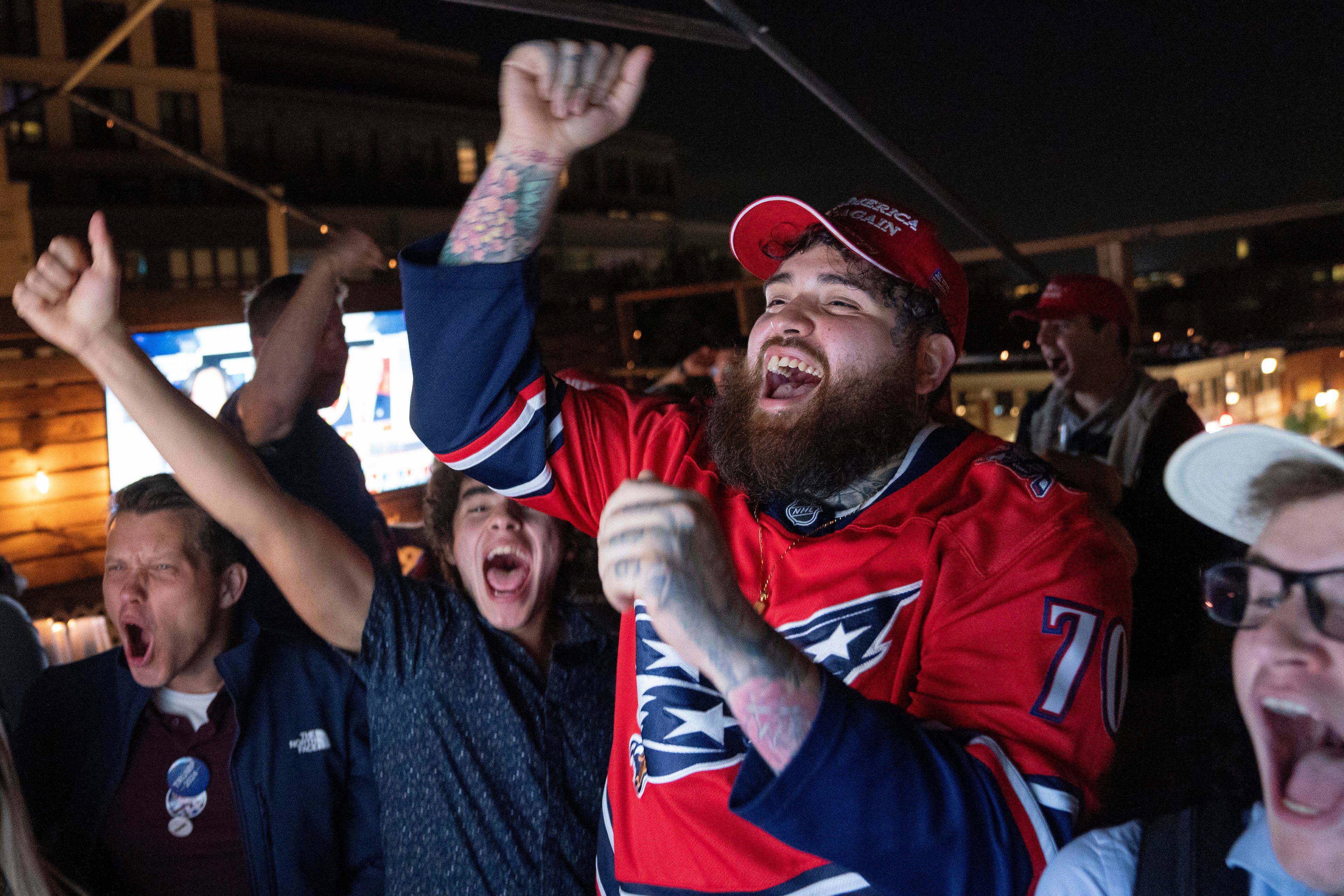 Supporters of Republican presidential nominee former President Donald Trump react to news that Trump won the state of Georgia during a watch party in Washington, Wednesday, Nov. 6, 2024. (AP Photo/Nathan Howard)