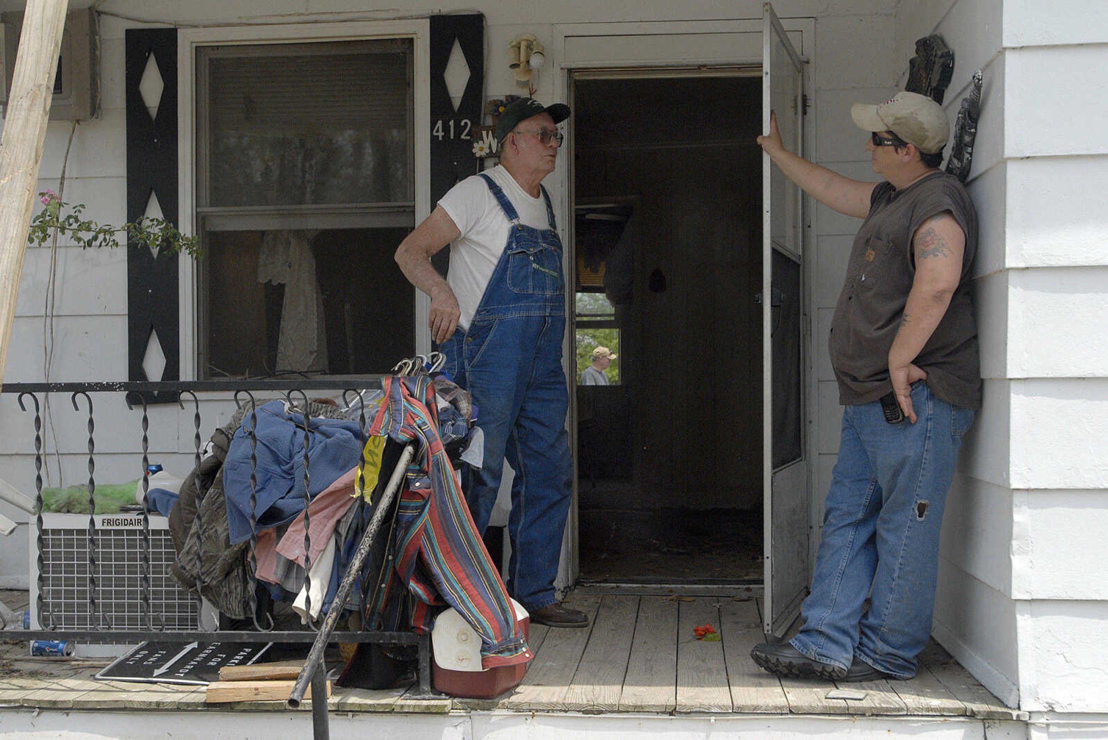 LAURA SIMON~lsimon@semissourian.com
David E. Jordan speaks with Lane Buerk on the front porch of his Boone Street home Wednesday, May 11, 2011 in Morehouse.