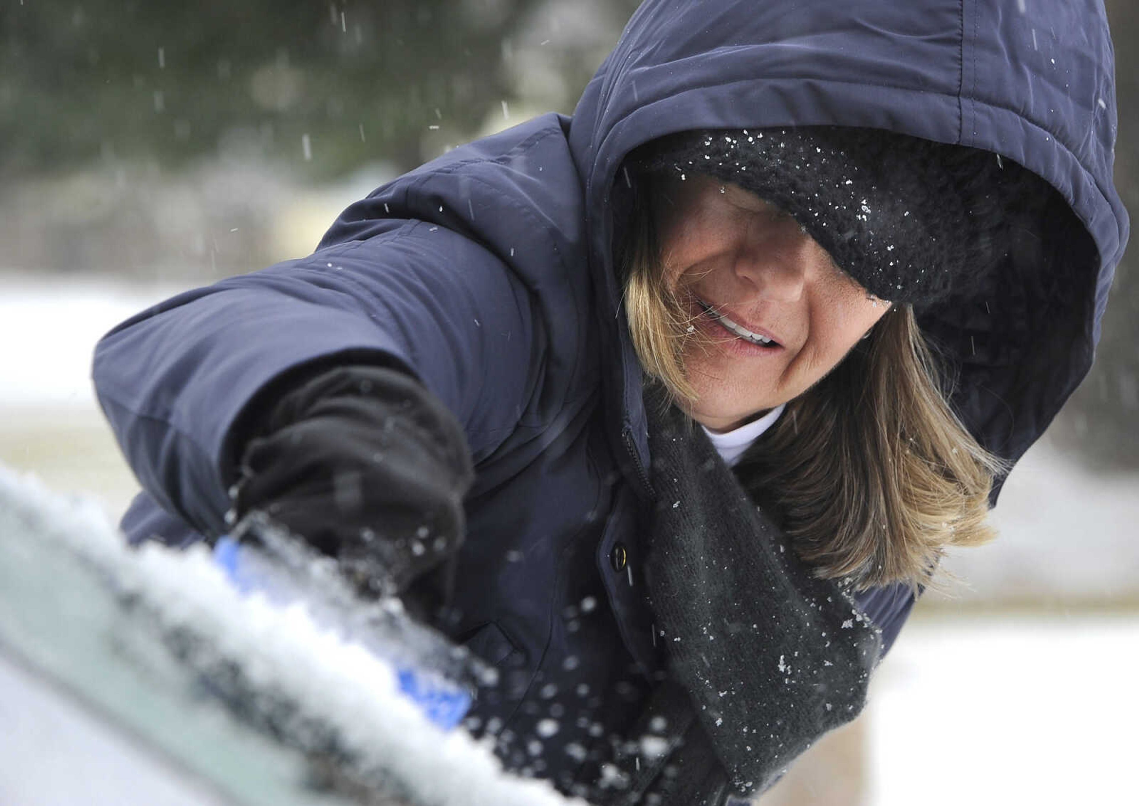 FRED LYNCH ~ flynch@semissourian.com
Connie Keener scrapes ice from her car windshield after attending Mass at Old St. Vincent's Church on Sunday morning, Feb. 14, 2016 in Cape Girardeau. "I was surprised to find it iced over," she said.