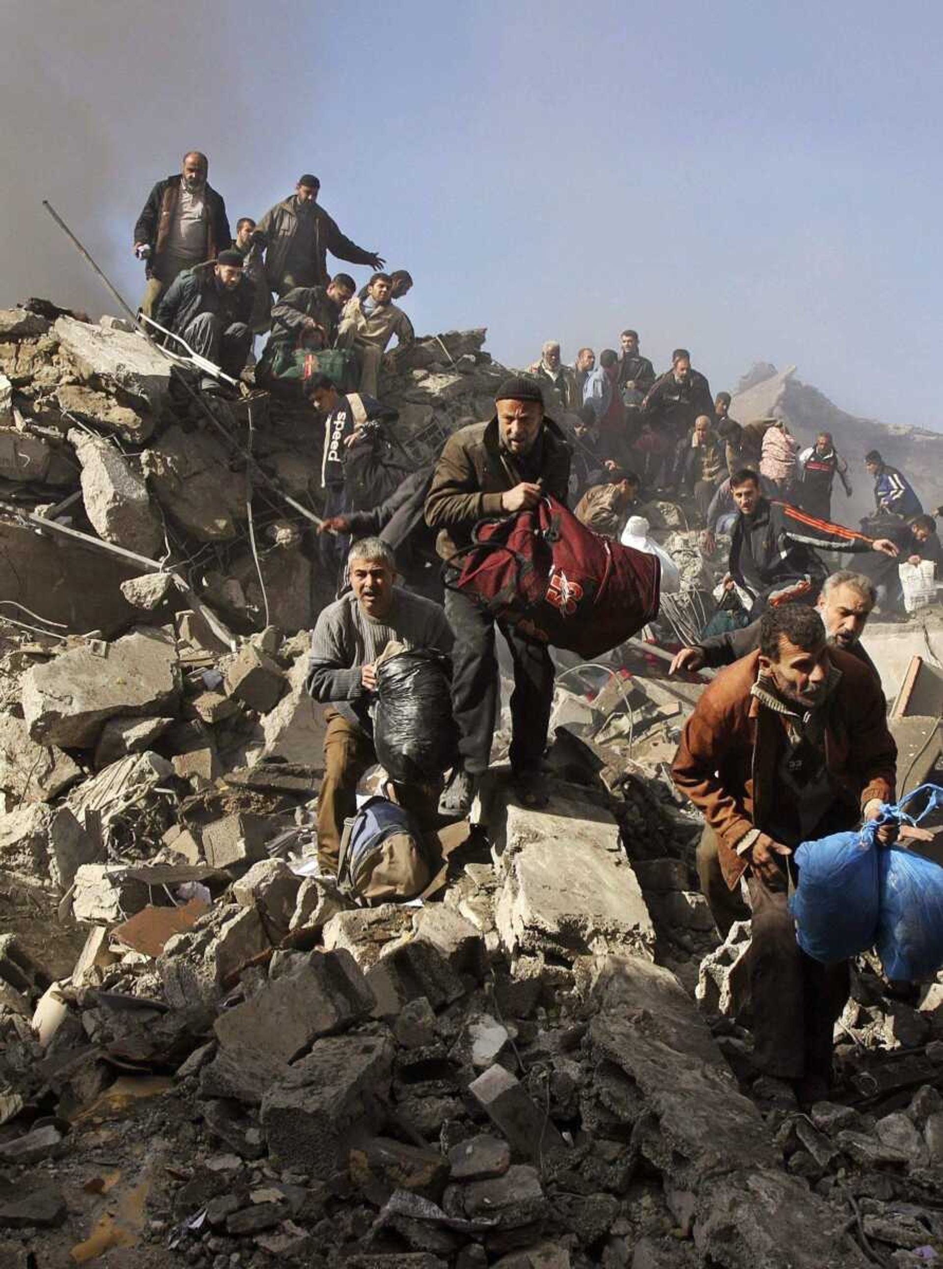 Adel Hana ~ Associated PressPalestinian prisoners flee over the rubble of the central security headquarters and prison, known as the Saraya, after it was hit during an Israeli missile strike Sunday in Gaza City. Some 290 Palestinians have been killed and 800 people wounded since Israel's campaign to quash rocket barrages from Gaza began midday Saturday, a Gaza health official said. Most of the dead were Hamas police.