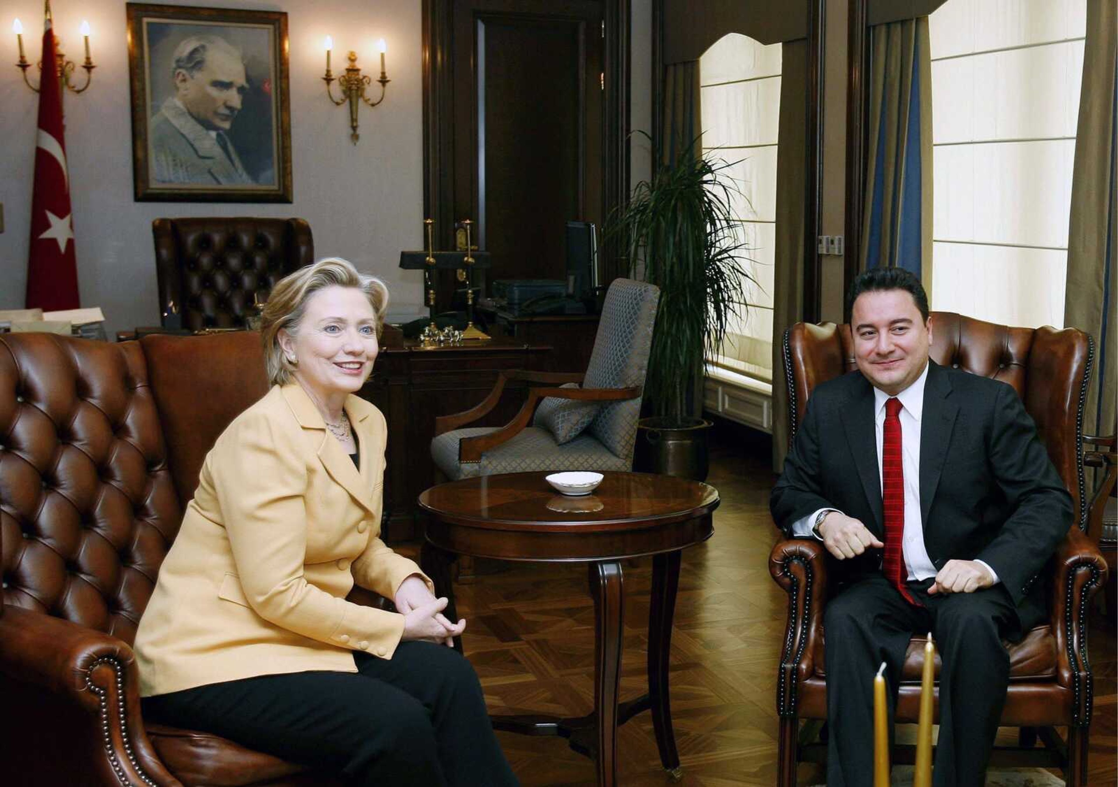 Tolga Bozoglu ~ Associated Press<br>U.S. Secretary of State Hillary Rodham Clinton, left, and Turkish Foreign Minister Ali Babacan look toward cameras Saturday during a meeting in Ankara, Turkey. President Obama will visit Turkey within the next month, Clinton said Saturday, in a sign of improving ties between the two NATO allies.