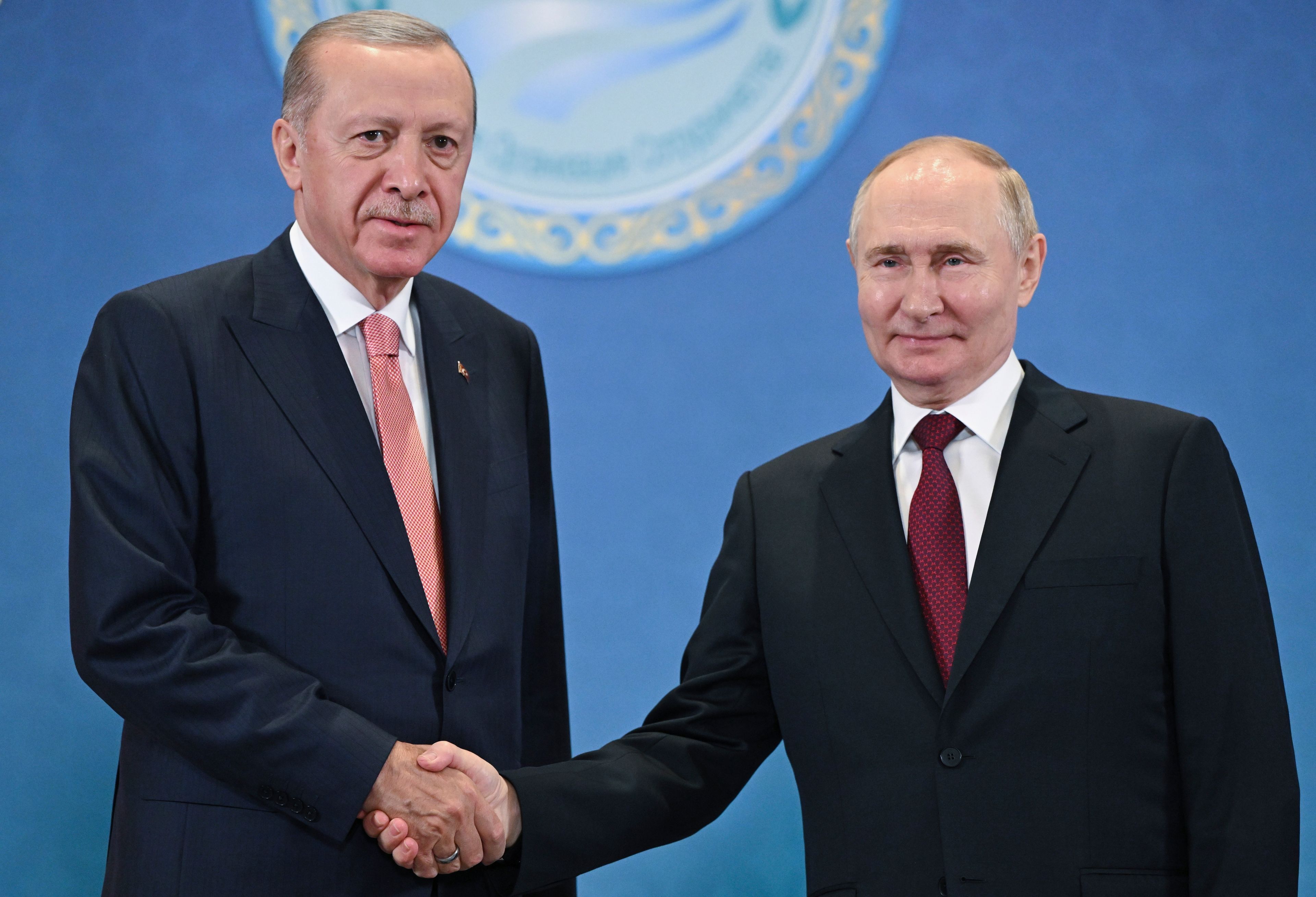 FILE - Russian President Vladimir Putin, right, and Turkey's President Recep Tayyip Erdogan shake hands as they pose for photos during a meeting on the sidelines of the Shanghai Cooperation Organization summit in Astana, Kazakhstan, on July 3, 2024. (Sergey Guneyev, Sputnik, Kremlin Pool Photo via AP, File)