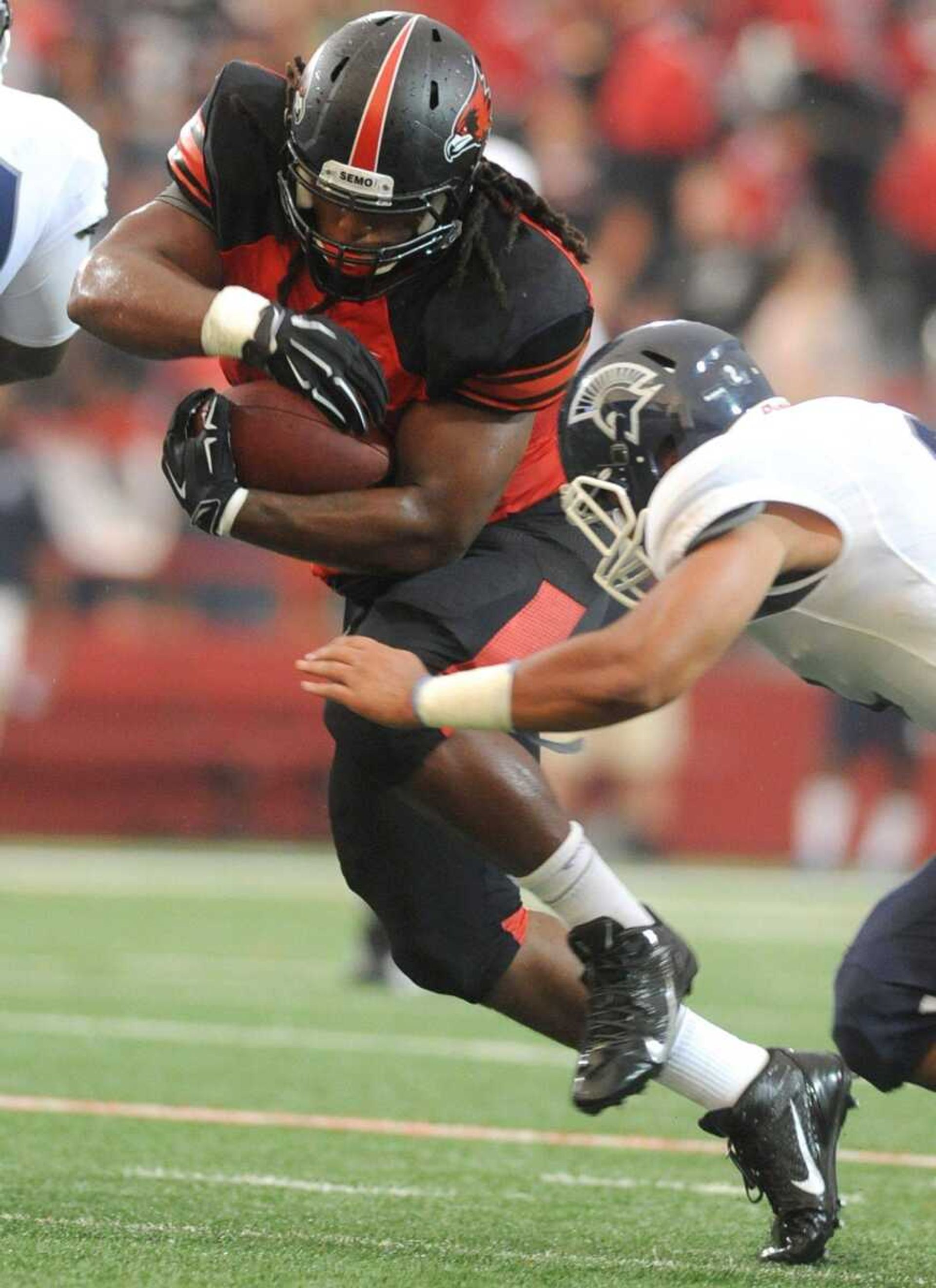 Southeast Missouri State's Ron Coleman avoids a tackle during the seasons first game against Missouri Baptist Thursday, Aug. 28, 2014 at Houck Stadium. (GLENN LANDBERG)