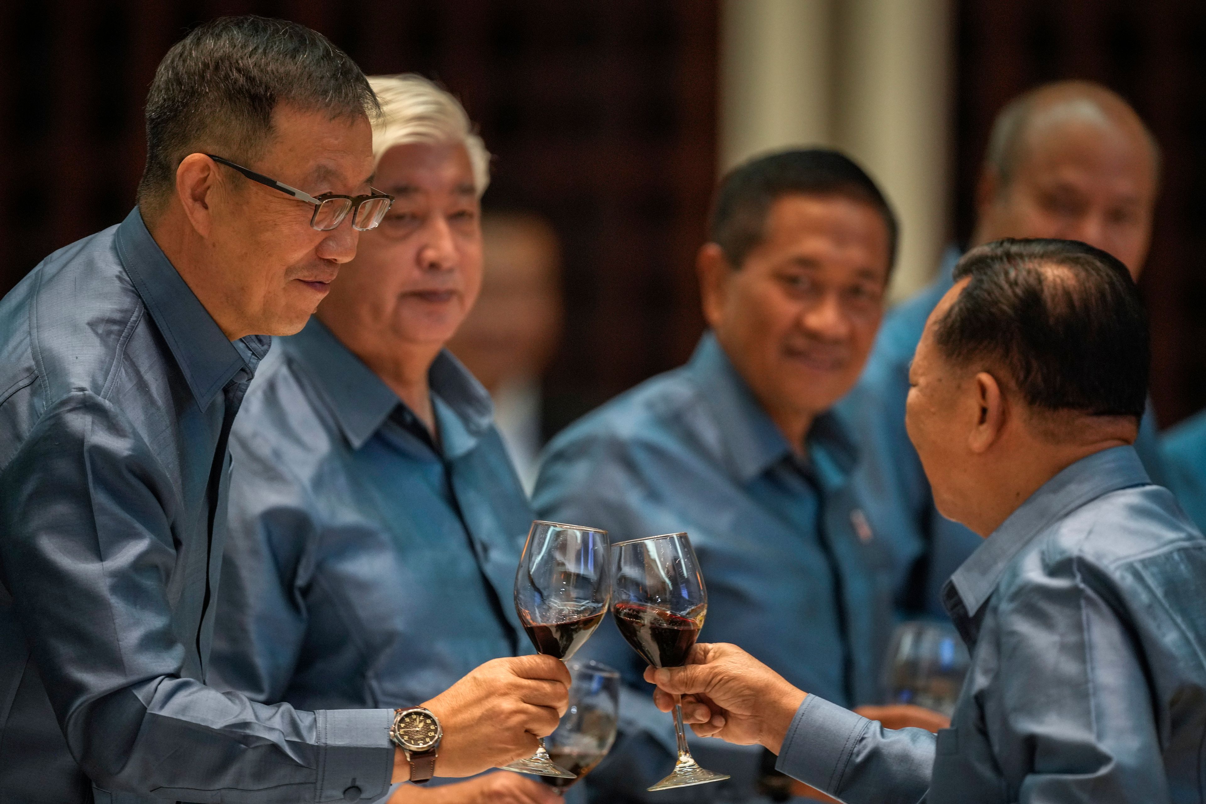 Chinese Defense Minister Dong Jun and Laos' Defence Minister Chansamone Chanyalath attend the gala dinner during the ASEAN defense ministers' meeting in Vientiane, Laos, Thursday, Nov. 21, 2024. (AP Photo/Anupam Nath)