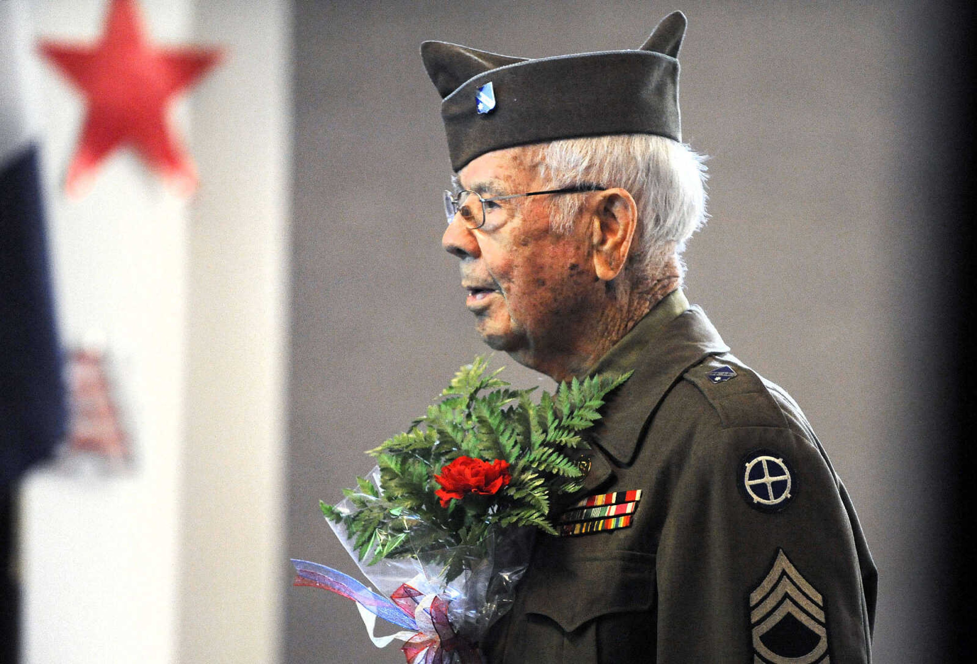 LAURA SIMON ~ lsimon@semissourian.com

Floyd Smith presents flowers in remembrance of one of the lost crew members of the Flying Fortress 812 during WWII on Monday, March 21, 2016, at Alma Schrader Elementary in Cape Girardeau.