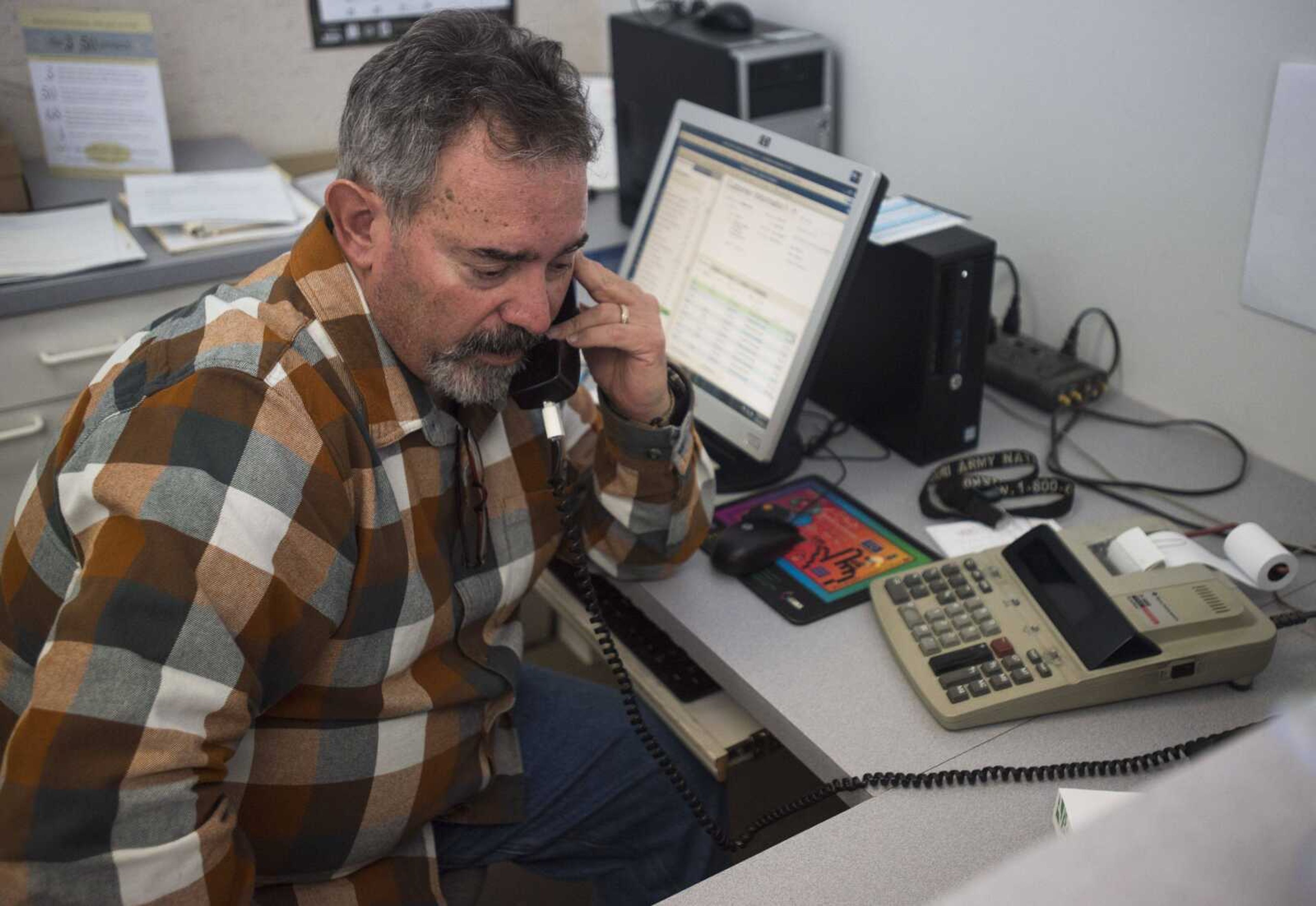 Steve Skelton takes a phone call at Benchmark Graphics & Printing on Friday in Jackson.