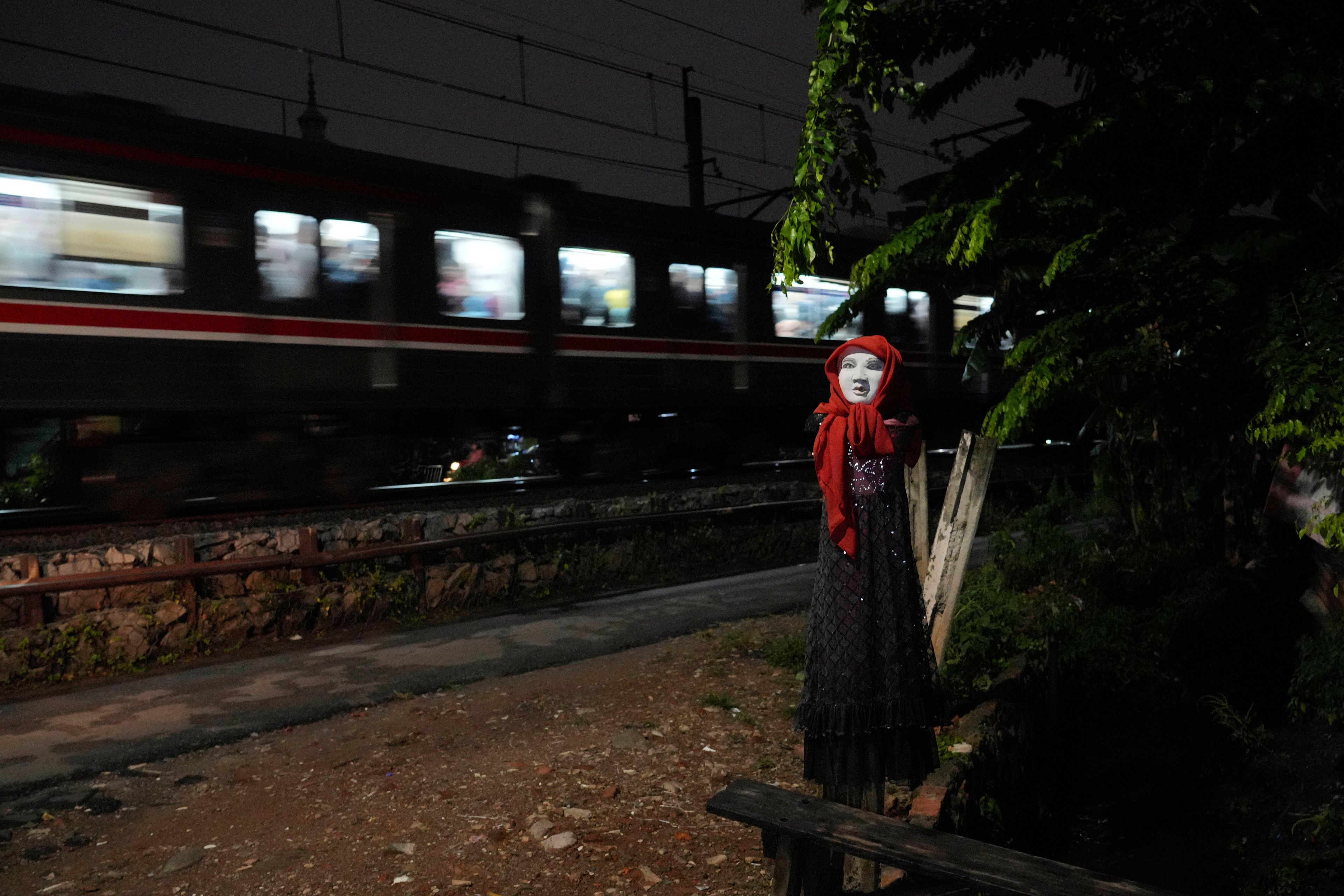 An effigy is seen near a railway track where two commuter trains collided in 1987, killing 139 people, in Bintaro, Indonesia, Friday, Oct. 25, 2024. (AP Photo/Tatan Syuflana)