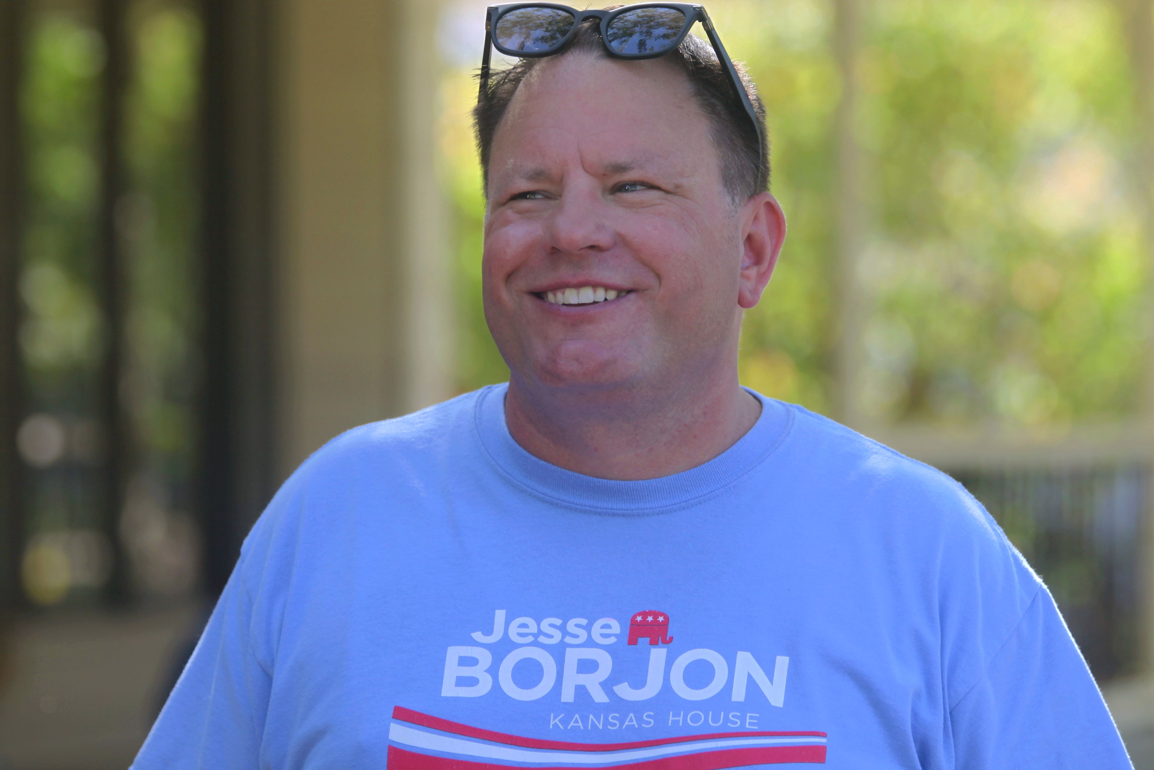 Kansas state Rep. Jesse Borjon speaks to a voter while campaigning door to door for reelection, Saturday, Oct. 5, 2024, in Topeka, Kansas. (AP Photo/John Hanna)