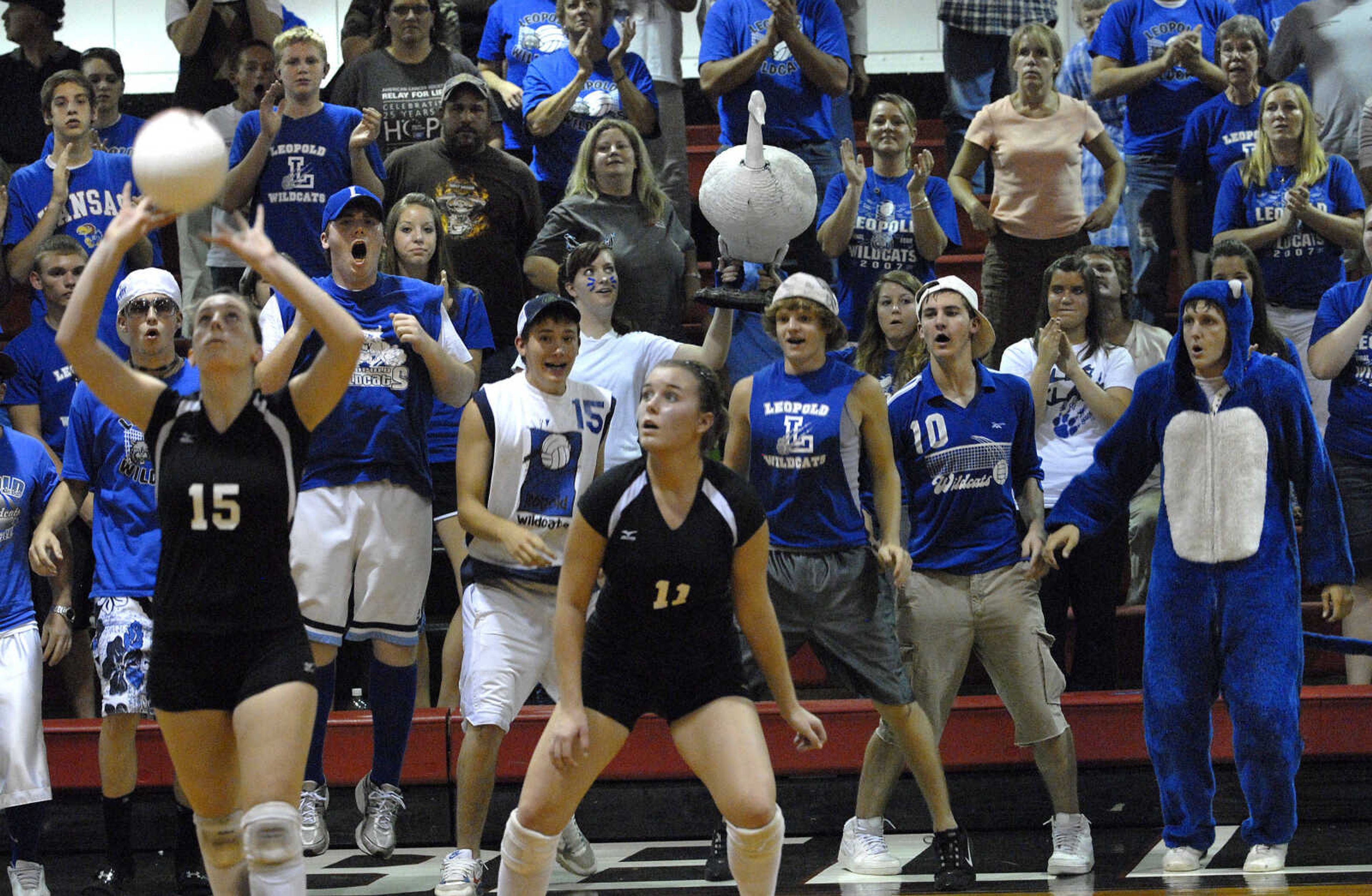 FRED LYNCH ~ flynch@semissourian.com
Bell City's Alicia Slagley sets the ball as teammate LaGena Strobel watches, while Leopold fans strut their stuff during the final moments of the match Friday at Bell City.