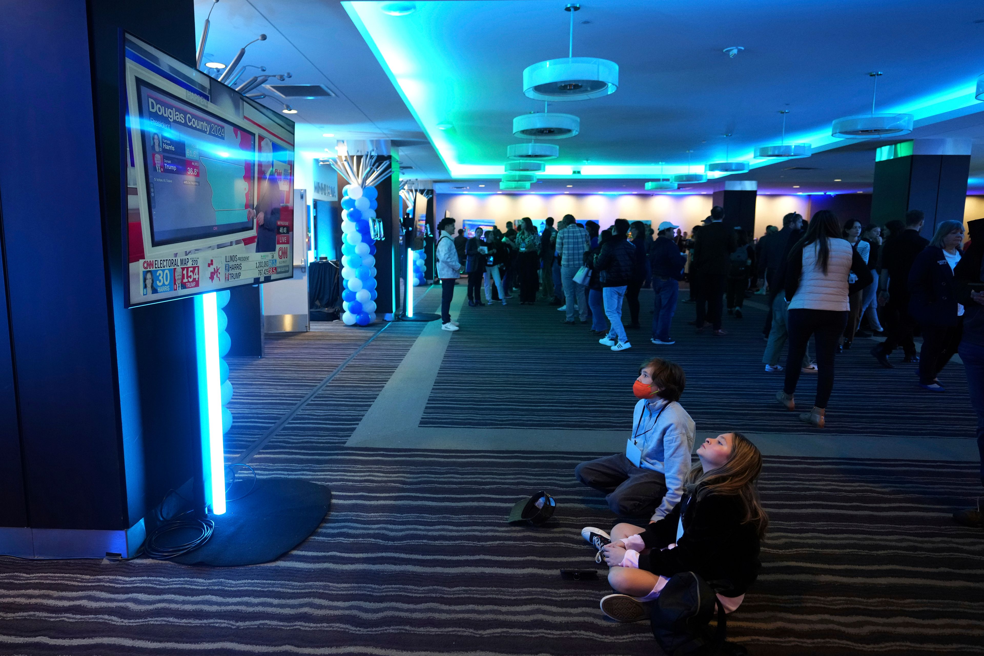 Children watch results come in on a television screen at the DFL election night party, Tuesday, Nov. 5, 2024, in St. Paul, Minn. (AP Photo/Abbie Parr)