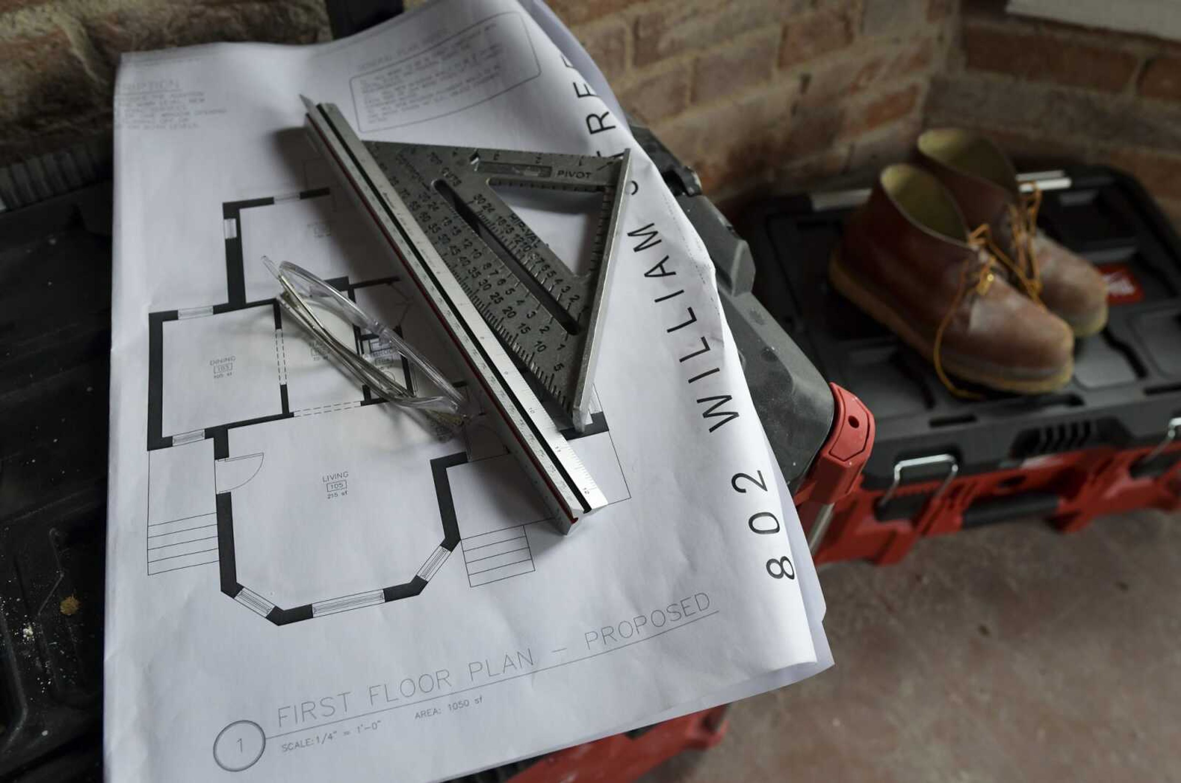 Safety glasses and tools rest atop a proposed floor plan for the first level of a home at 802 William St. on March 11 in Cape Girardeau.