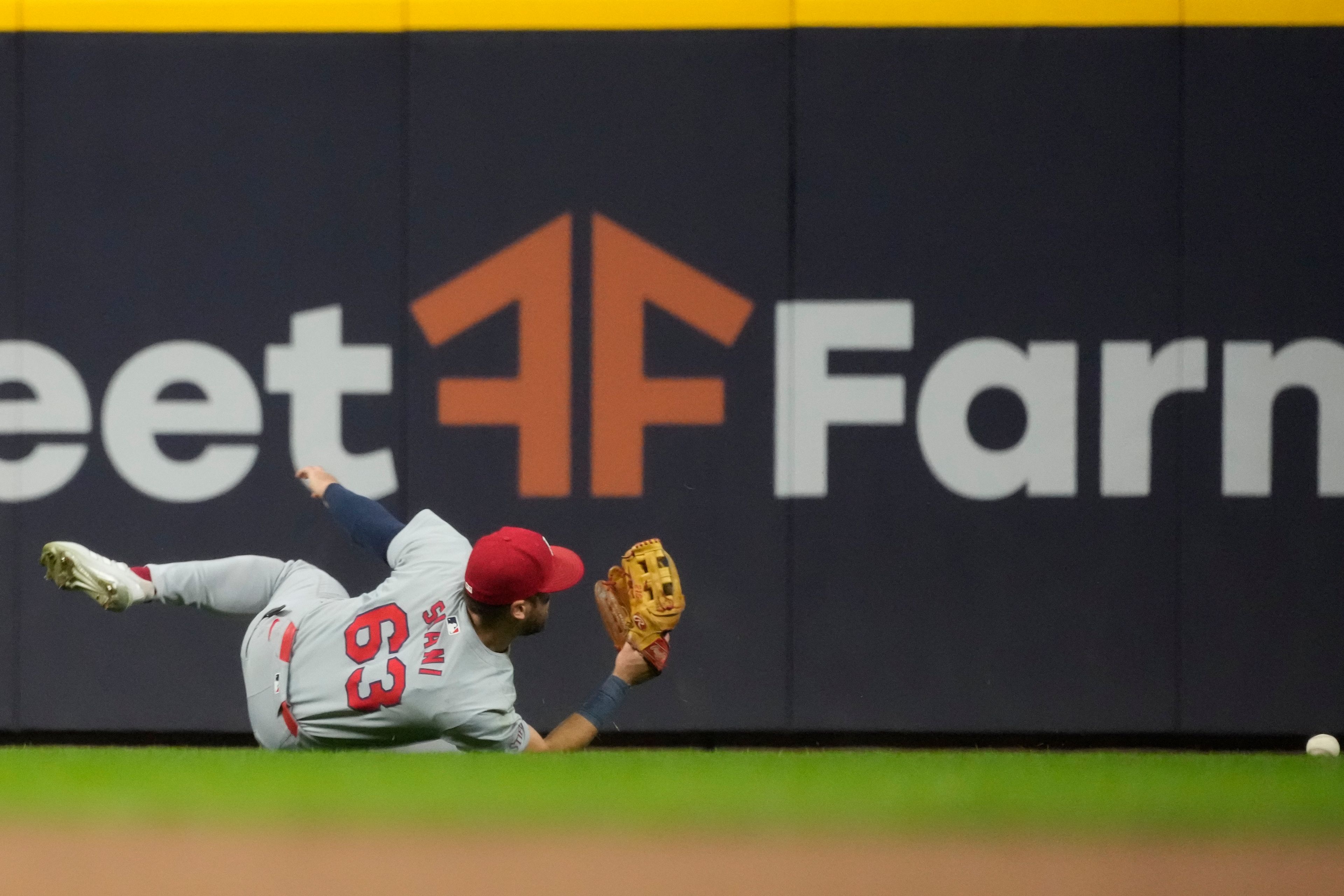 St. Louis Cardinals' Michael Siani can't catch a ball hit by Milwaukee Brewers' Willy Adames during the 11th inning of a baseball game Tuesday, Sept. 3, 2024, in Milwaukee. (AP Photo/Morry Gash)