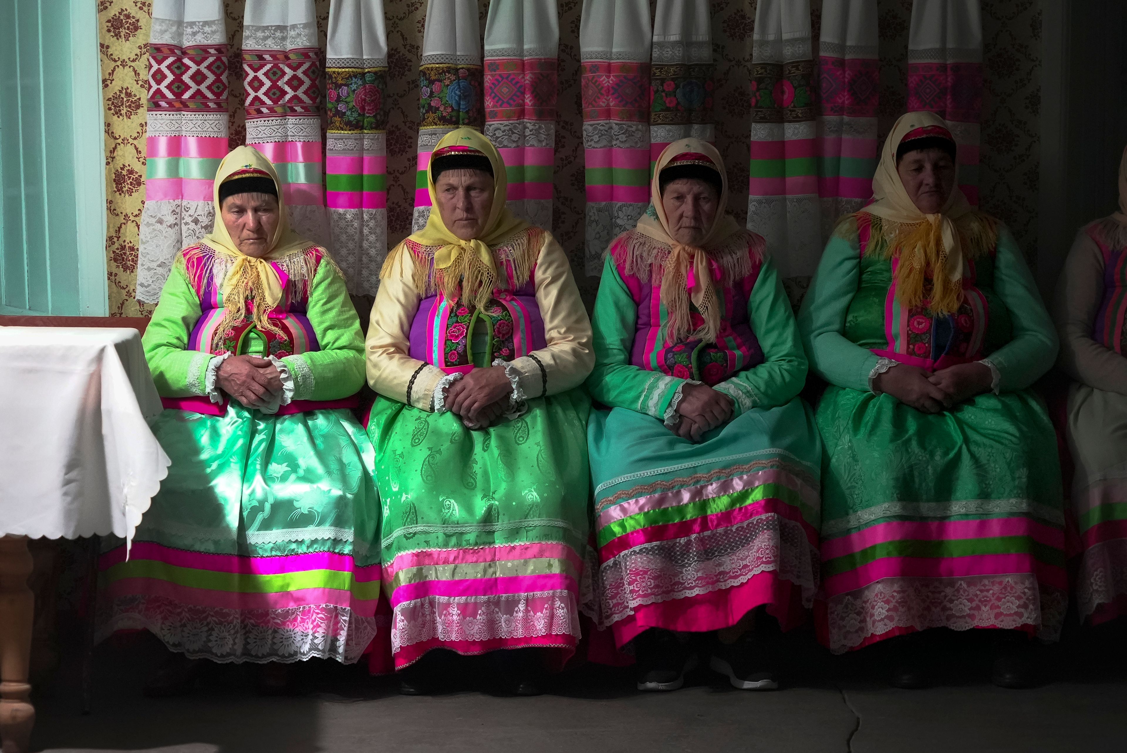 Women in traditional Doukhobor dresses pray at the former Orphanage house where Doukhobors has worshiped for years, on Easter in the remote mountain village of Gorelovka, Georgia, Saturday, May 4, 2024. (AP Photo/Kostya Manenkov)