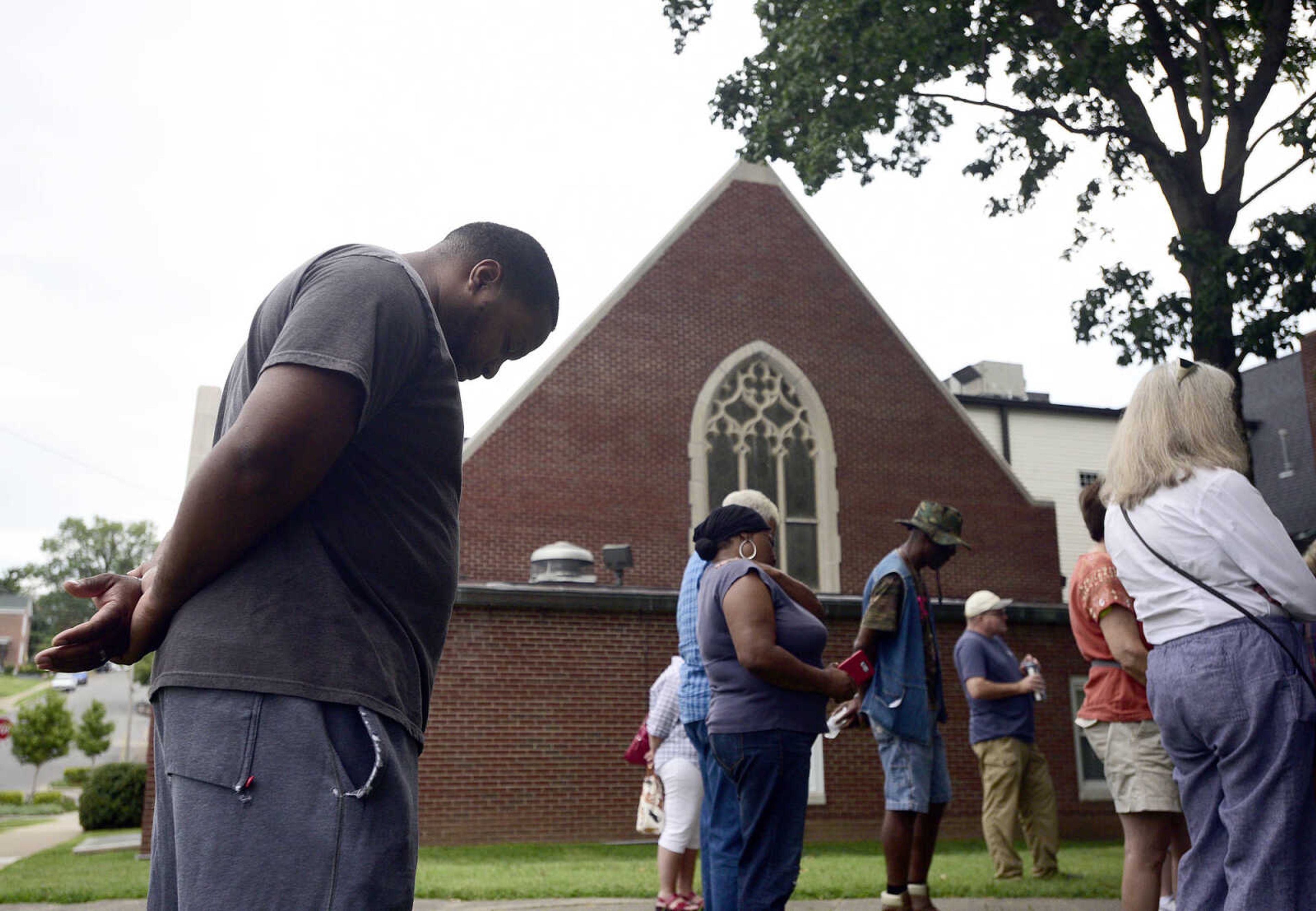 Stafford Moore Jr. bows his head during the closing song of the Love, Not Hate rally on Sunday evening, Aug. 13, 2017, at Ivers Square in Cape Girardeau.