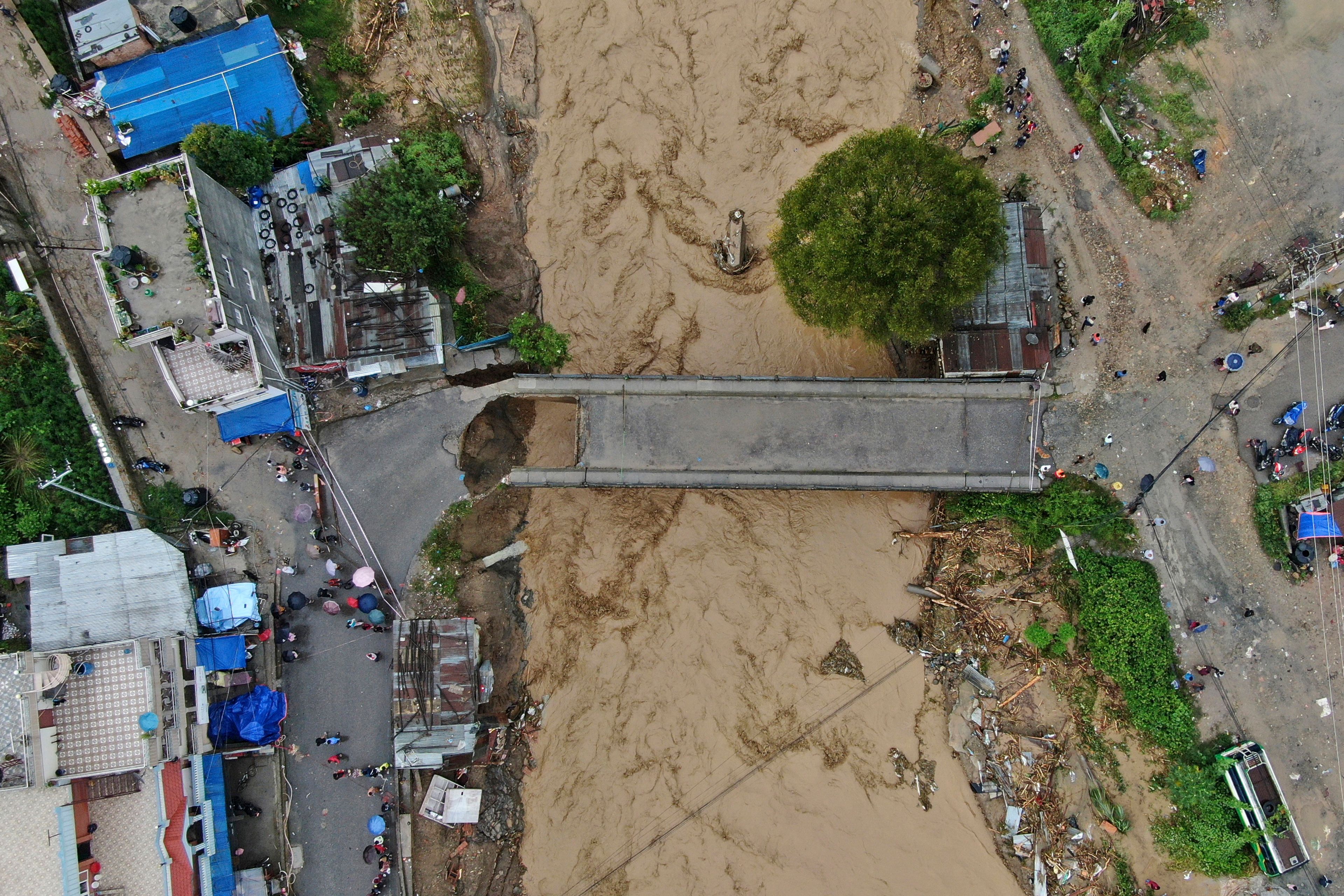 In this aerial image of the Kathmandu valley, Bagmati River is seen in flood due to heavy rains in Kathmandu, Nepal, Saturday, Sept. 28, 2024. (AP Photo/Gopen Rai)