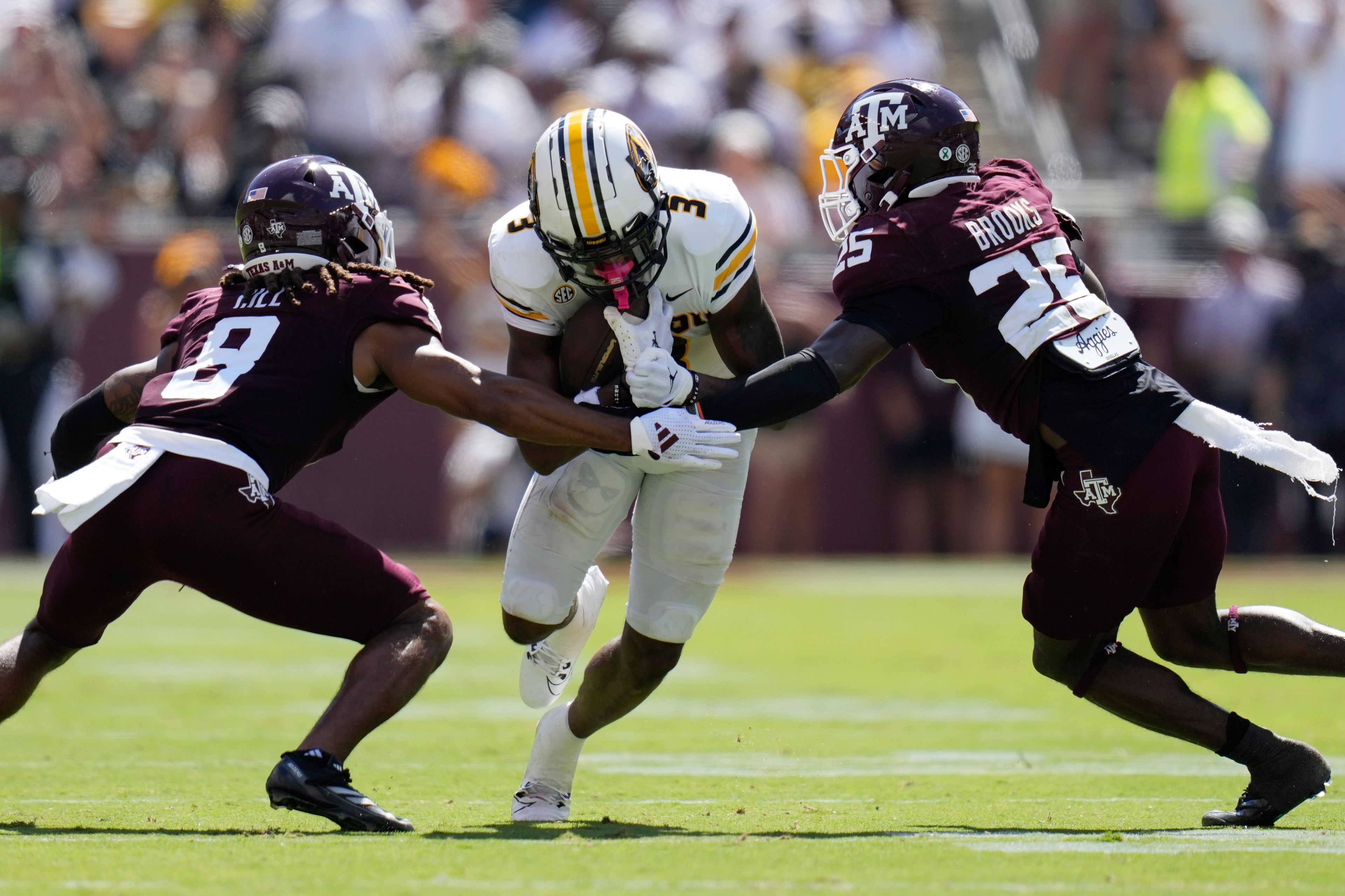 Missouri wide receiver Luther Burden III (3) is stopped by Texas A&M running back AJ DiNota (25) and defensive back Dalton Brooks (25) after a catch during the second half of an NCAA college football game Saturday, Oct. 5, 2024, in College Station, Texas. (AP Photo/Eric Gay)