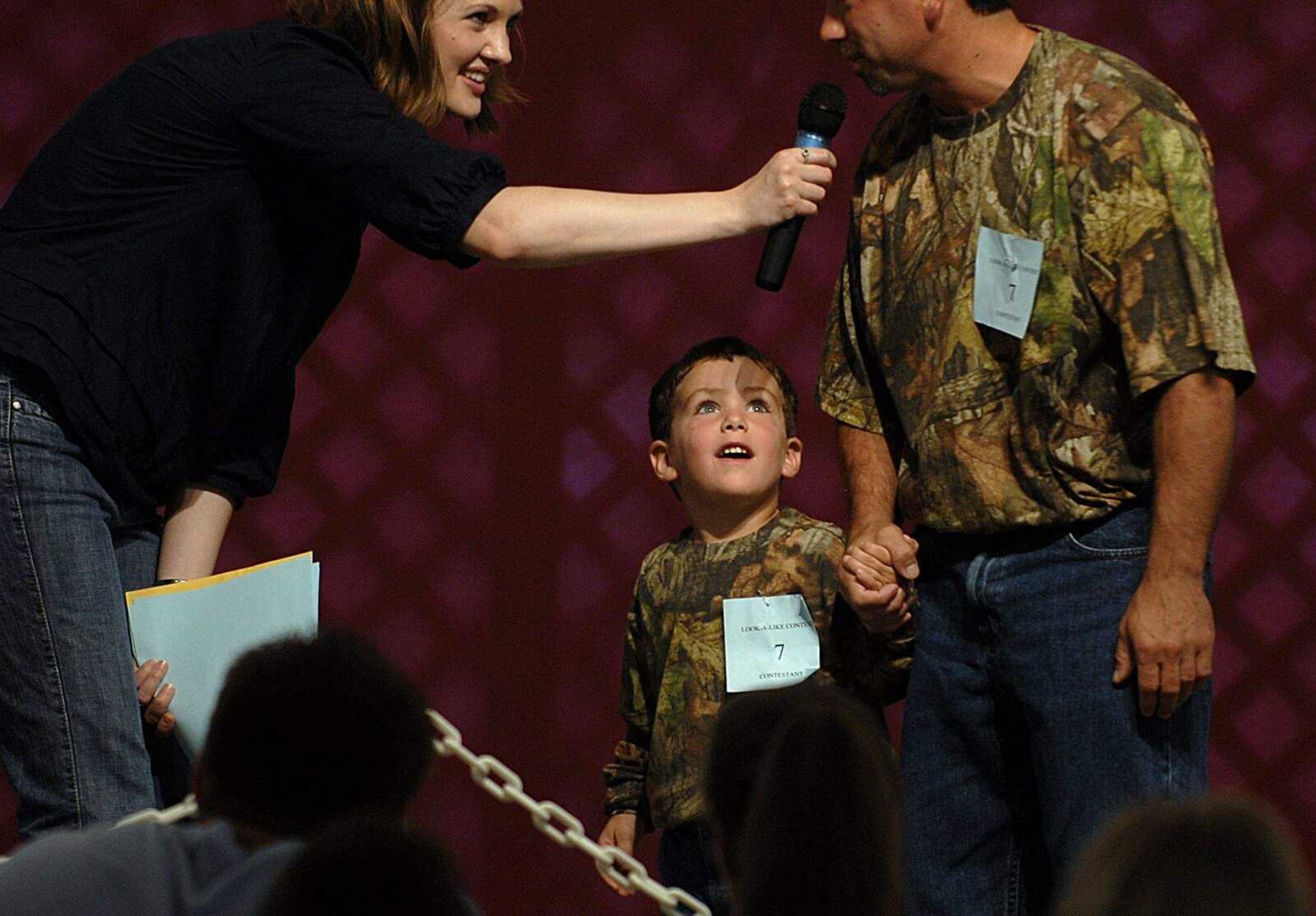 AARON EISENHAUER ~ aeisenhauer@semissourian.com
Three-year-old Nathan Landewee looks up to his father Edward Landewee as they answer questions on stage in the Father/Son Look-A-Like Contest on Thursday, September 11, 2008. The Landewees took the prize for first place.