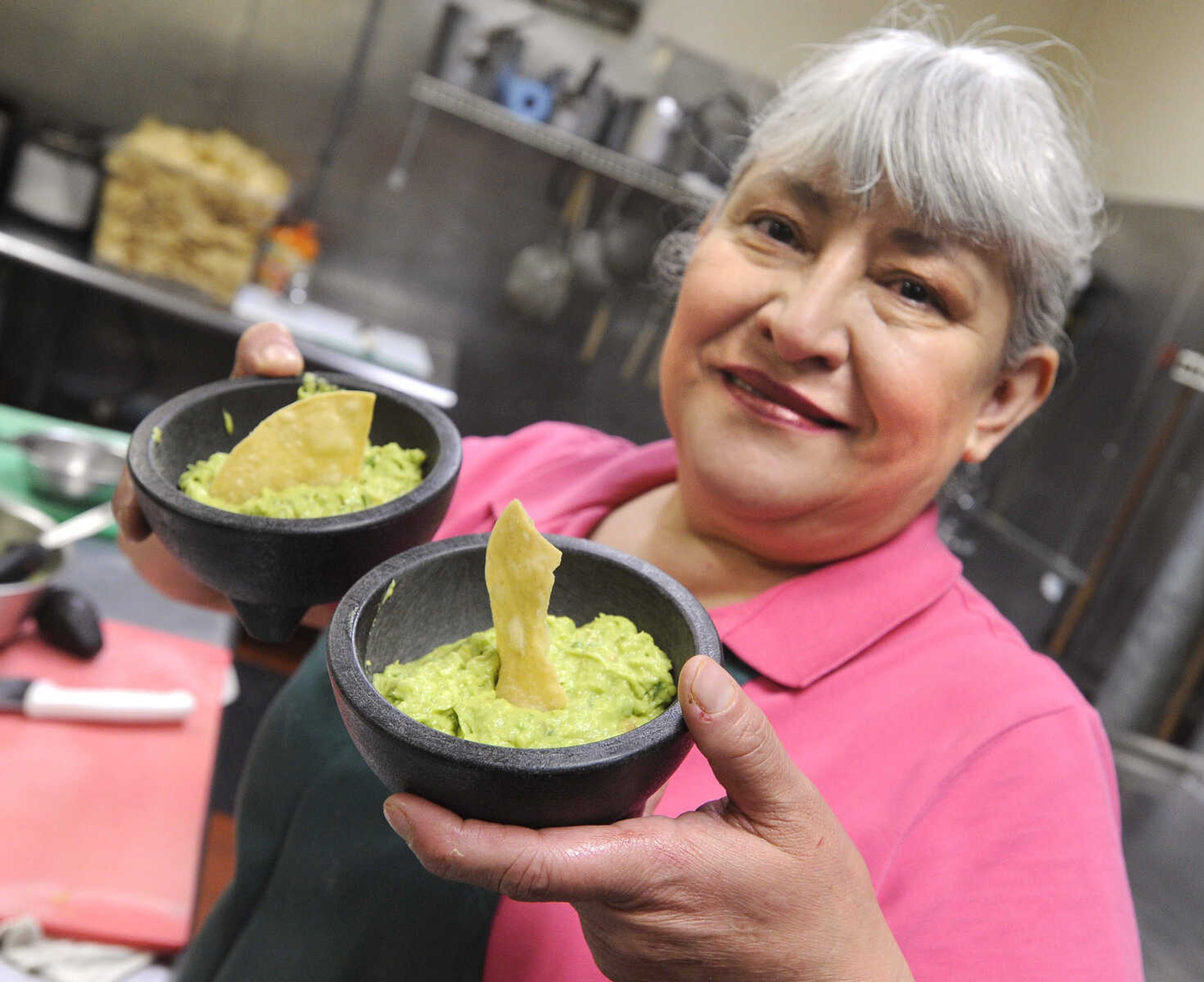 FRED LYNCH ~ flynch@semissourian.com
Gracie Aguirre shows guacamole that she makes fresh for each patron Friday, March 20, 2015 at Muy Bueno in Cape Girardeau.