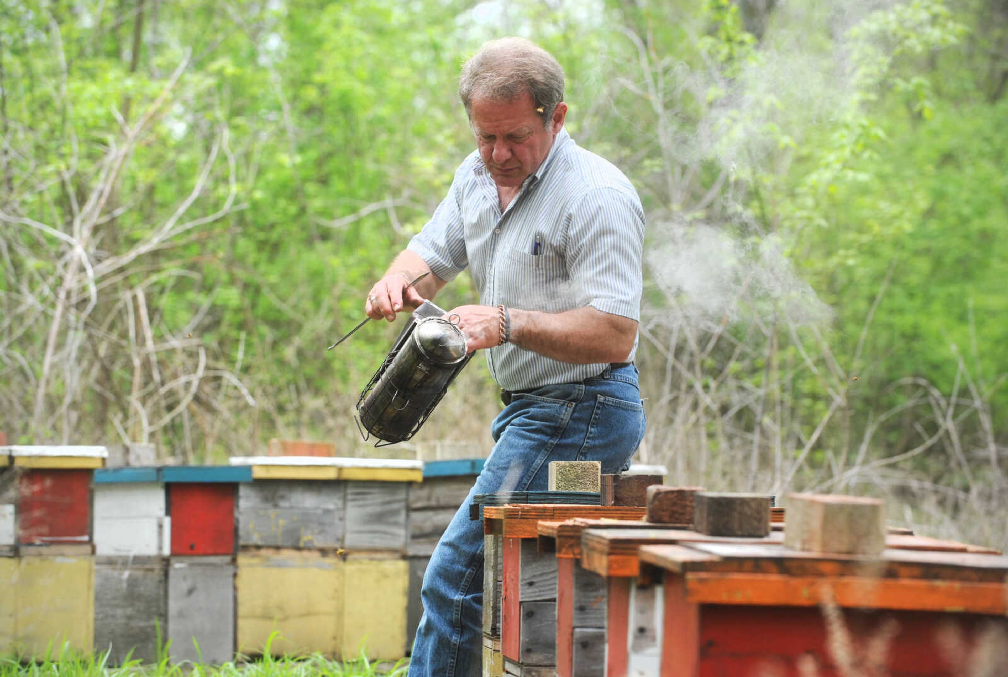 LAURA SIMON ~ lsimon@semissourian.com

Grant Gilliard checks on his beehives in Cape Girardeau County.