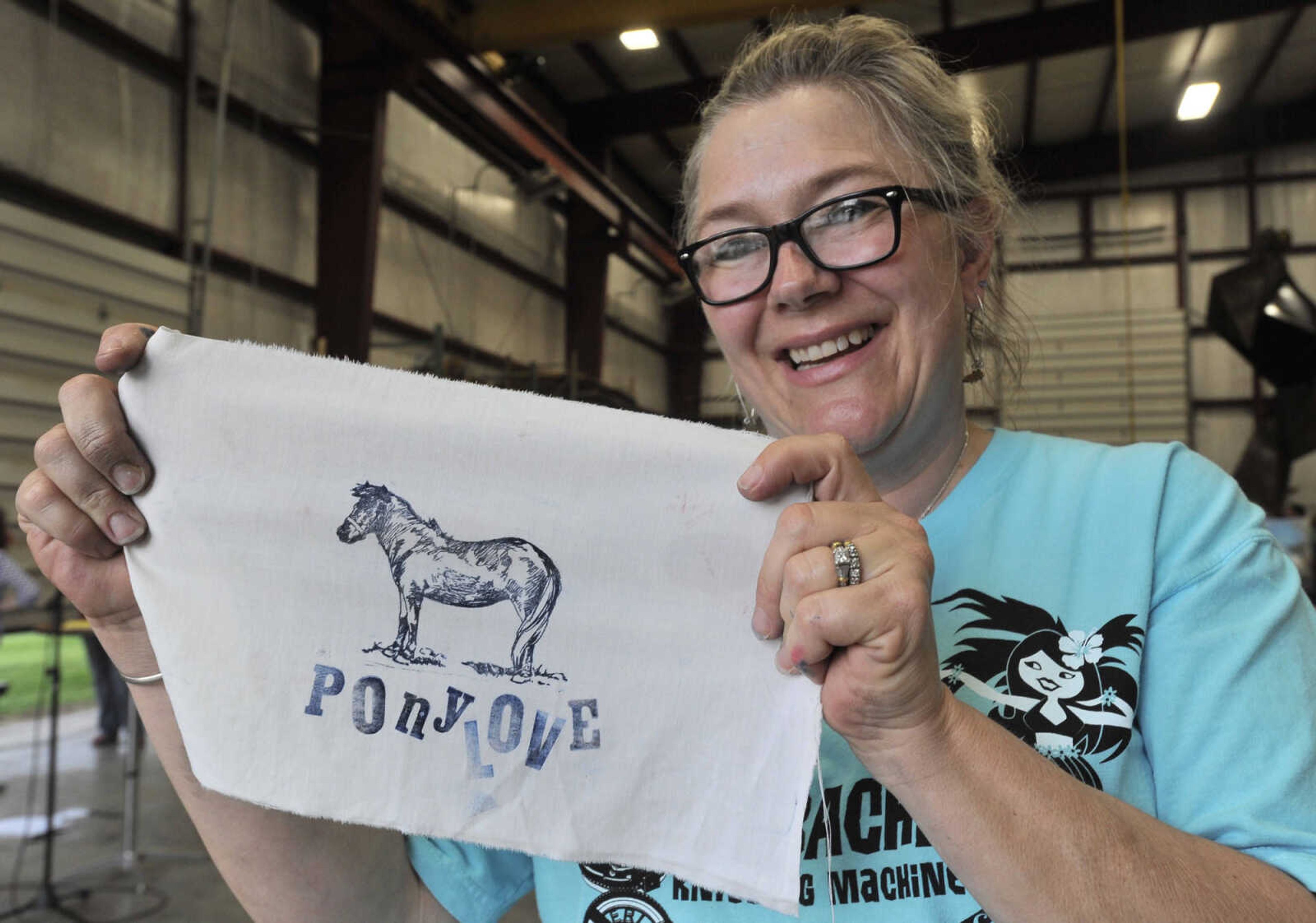 FRED LYNCH ~ flynch@semissourian.com
Jamie Mayfield shows the block print she made Thursday, April 20, 2017 during ARTrageous at Erlbacher Gear and Machine Works in Cape Girardeau.