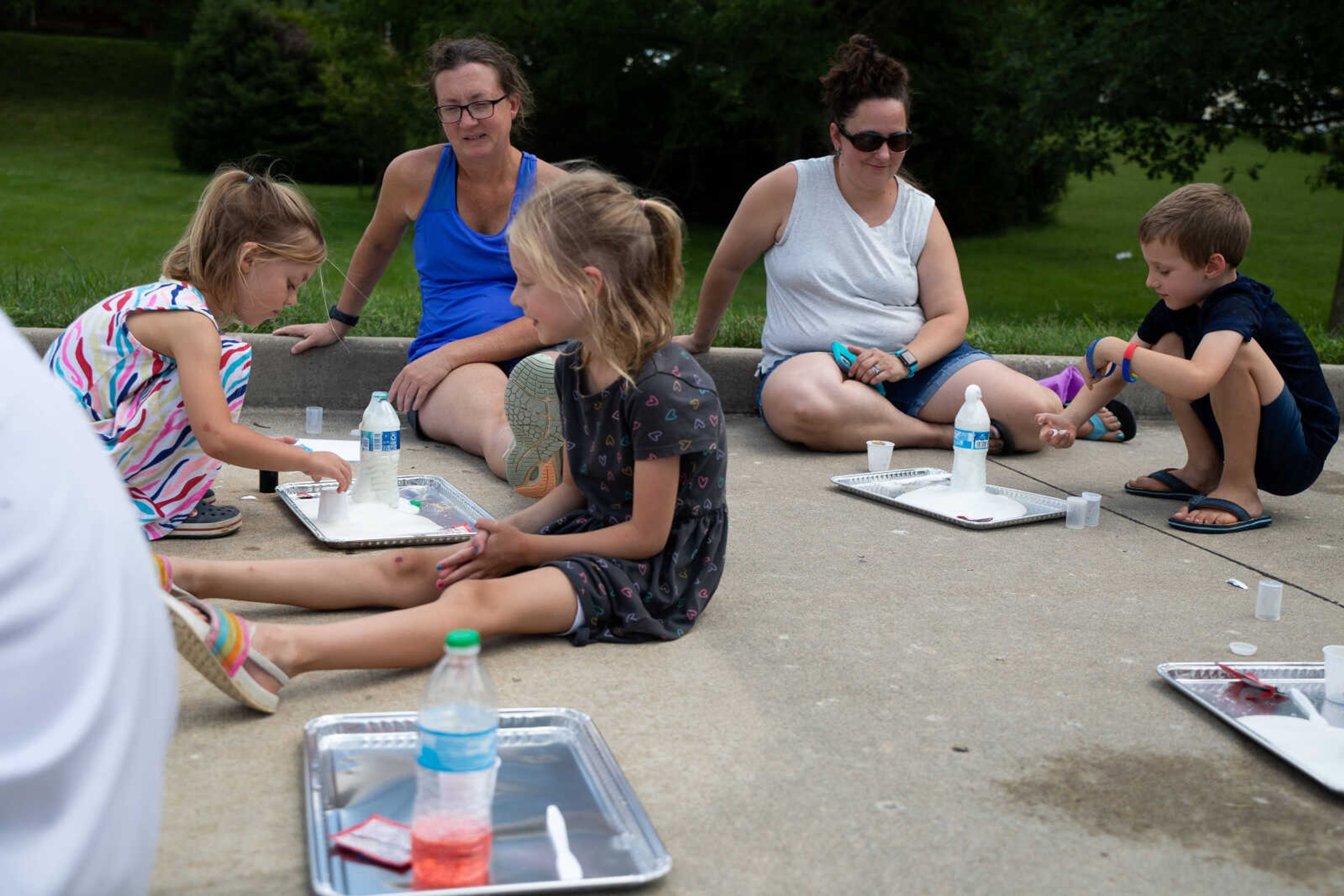 Lori Heuring, left, watches her daughters Avery and Morgan Heuring so experiments.