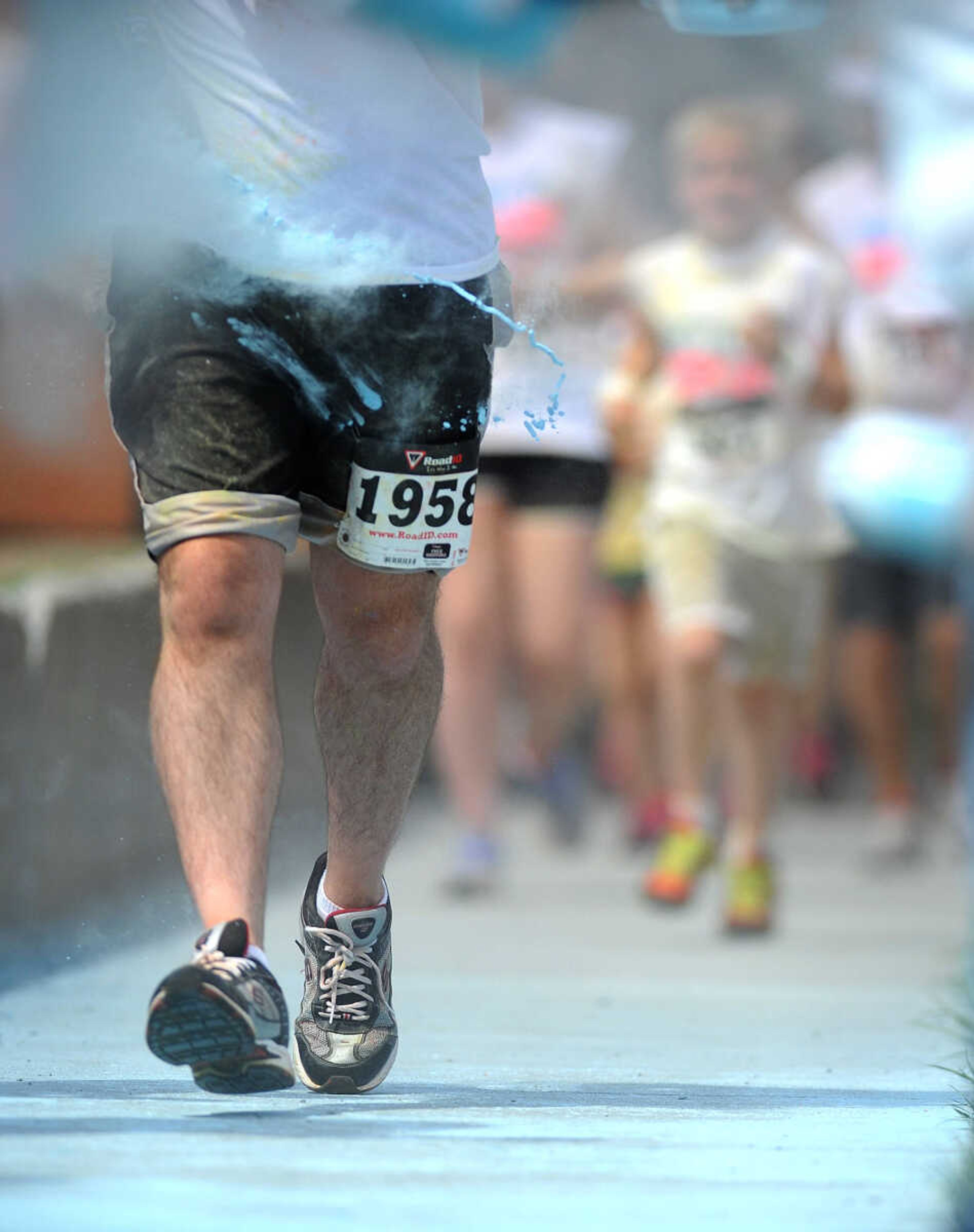 LAURA SIMON ~ lsimon@semissourian.com

Participants in the Color Me Cape 5K are sprayed with blue powder at the final color station on Main Street, Saturday, April 12, 2014, in Cape Girardeau.