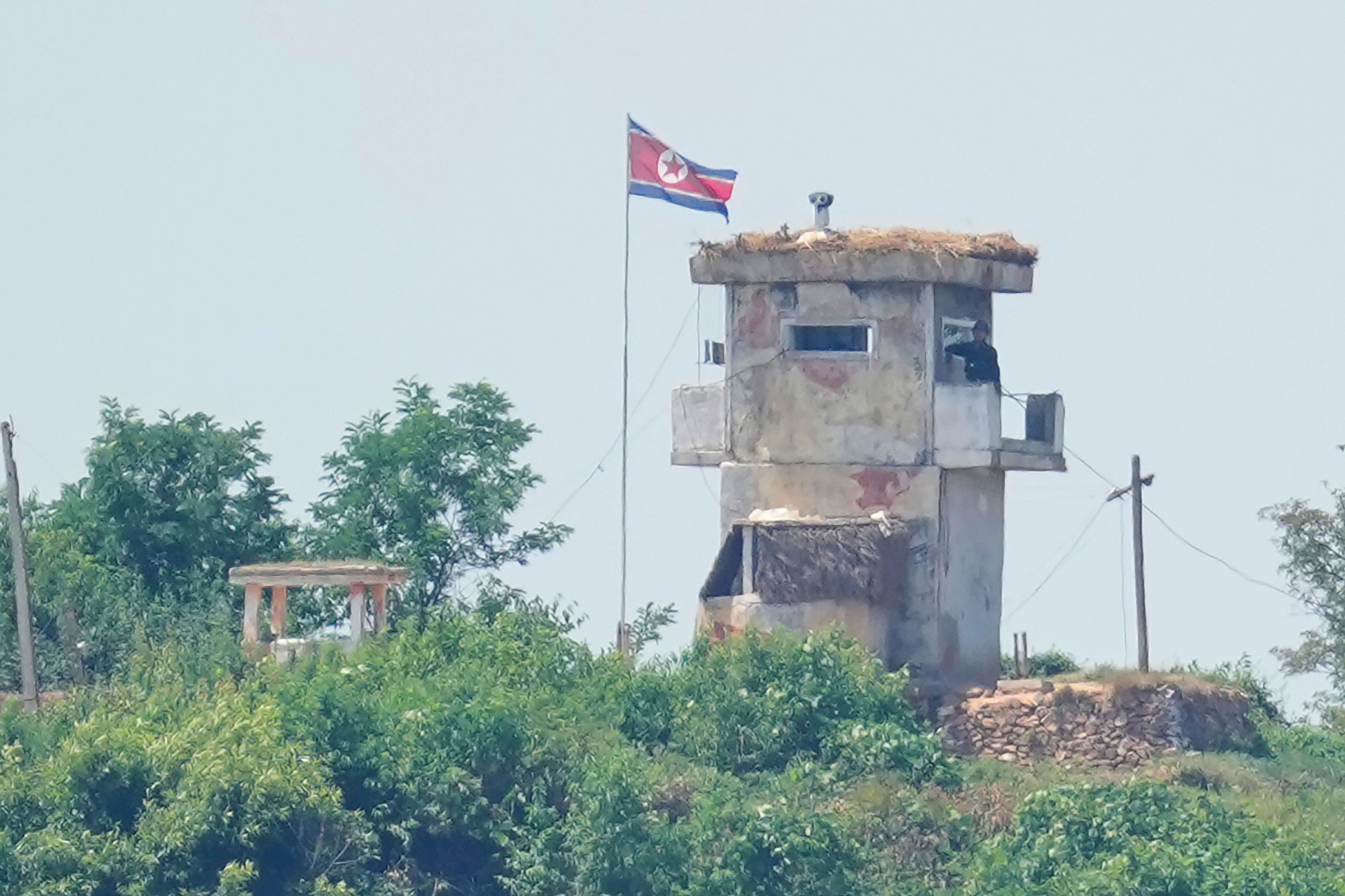 FILE - A soldier stands at a North Korean military guard post flying a national flag, seen from Paju, South Korea, Wednesday, June 26, 2024. (AP Photo/Lee Jin-man, File)