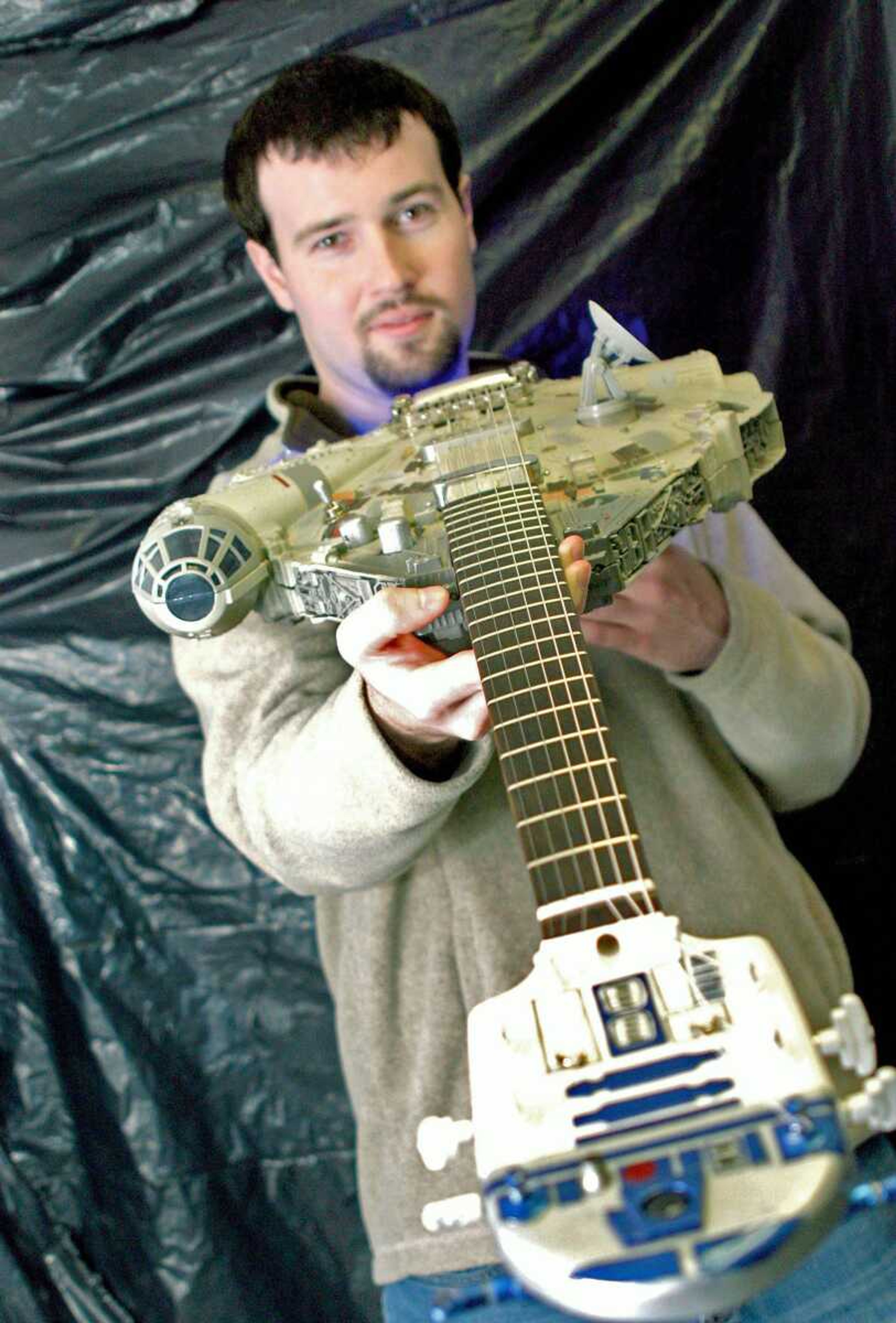 Brian Fisk shows his Millennium Falcon guitar. A video clip featuring the custom-built guitar on YouTube has had more than 81,000 viewings and prompted an interview with Fisk by CNN. (Scott Welton/Standard Democrat)